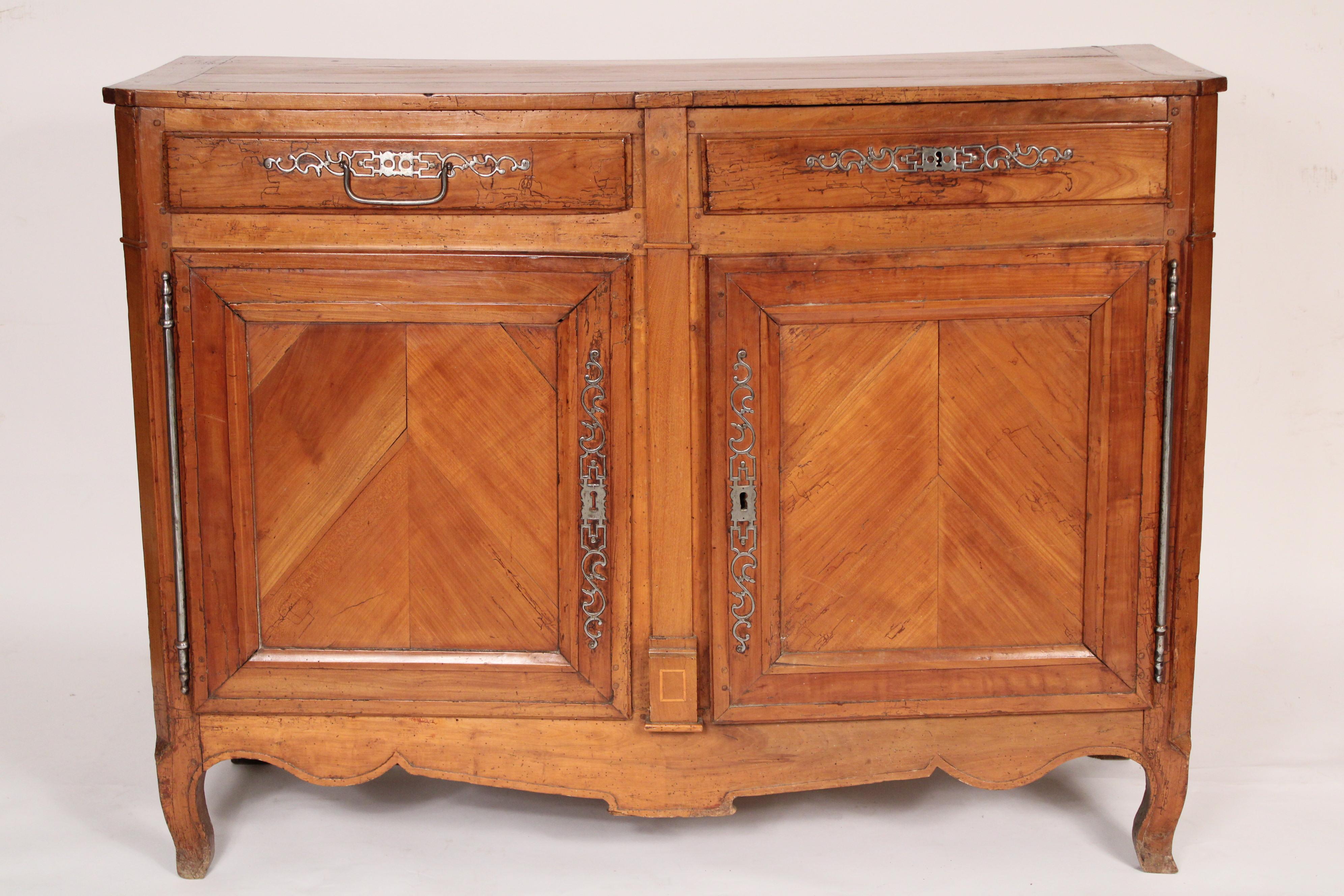 Antique Louis XV style fruit wood buffet, 19th century. With a slightly overhanging rectangular top, canted corners, two drawers with steel hardware one with handle, two doors with herringbone panels resting on petite cabriole feet. Mortise and