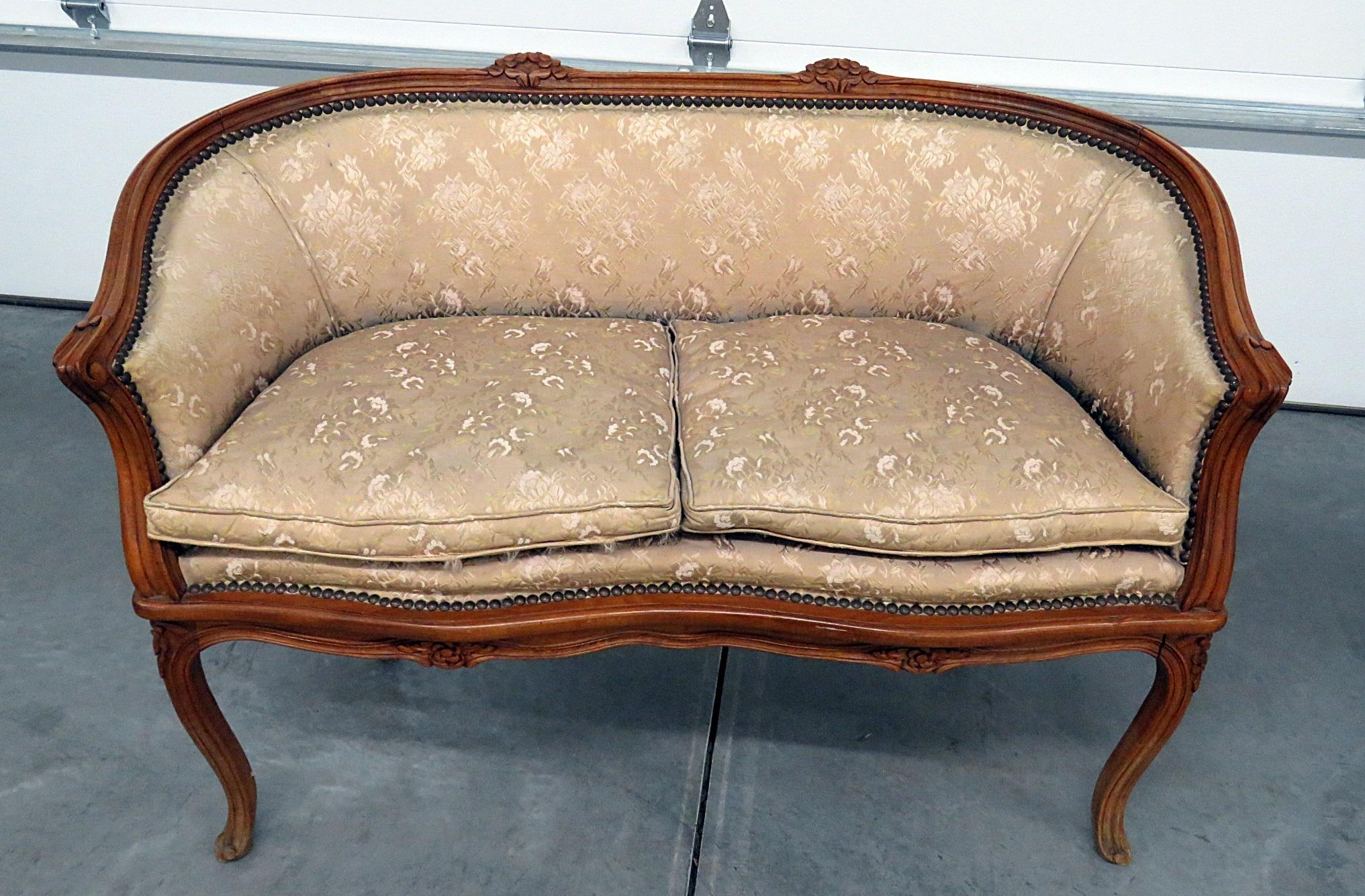 Antique Louis XV style carved settee with nailhead trim.