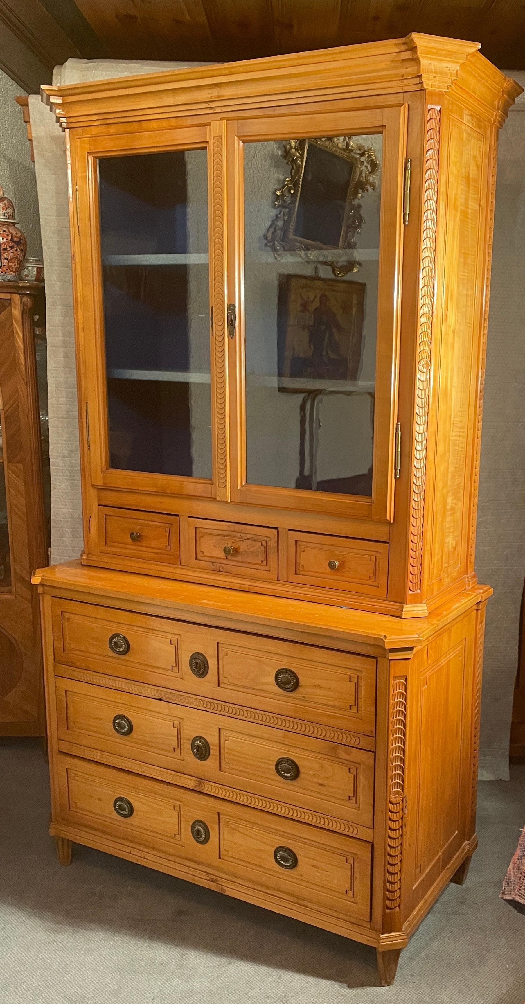 This unique antique Louis XVI Buffet comes from southern Germany and dates back to around 1780. It is made of cherry veneer and massive cherry wood. The buffet's lower part has a chest of drawers with three large drawers. On the upper part is a