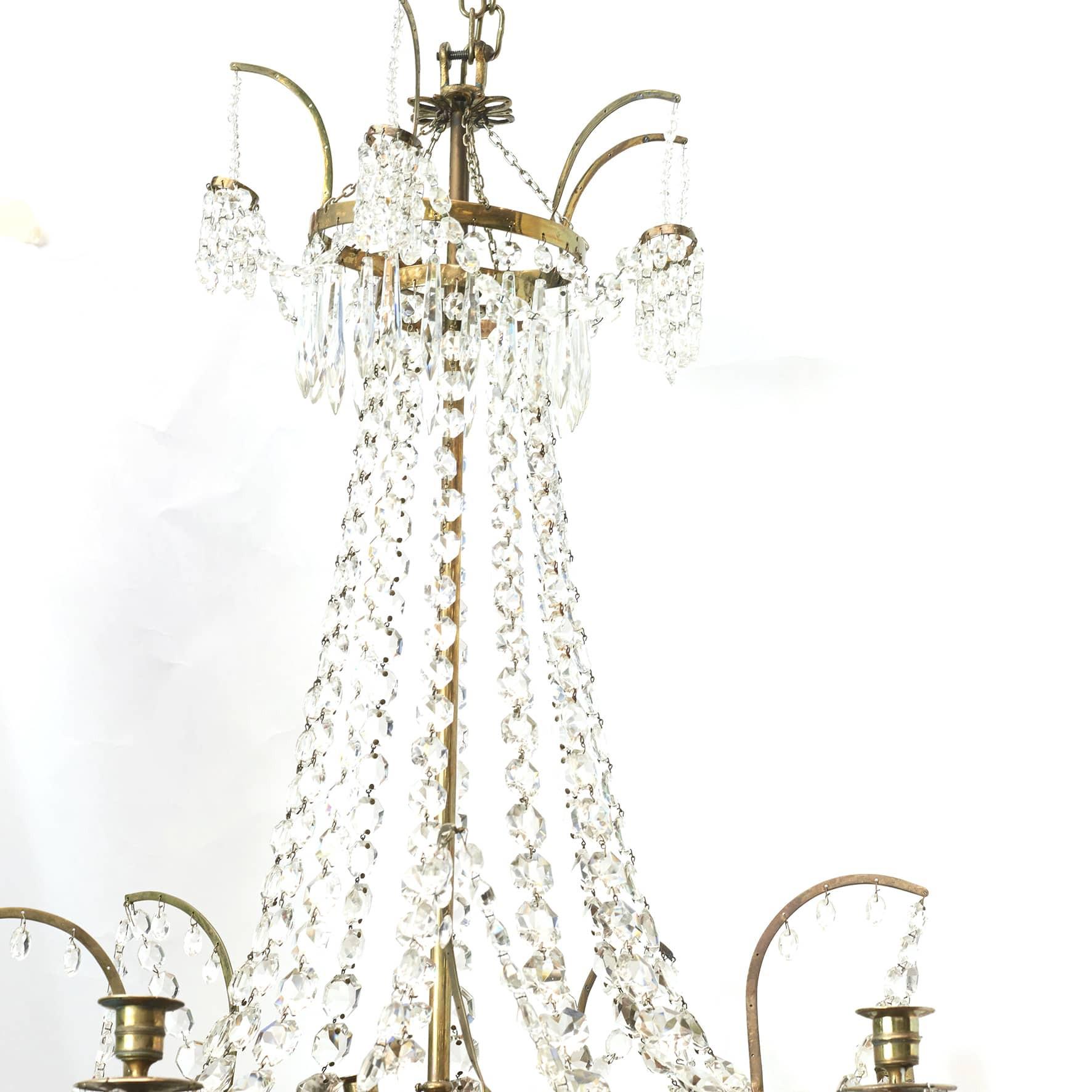 Elegant Louis XVI chandelier with crystal Prisms.

Polished brass frame with 6 light arms and reduced rounding with blue glass.
Denmark 1780 - 1800.

Can be electrified.