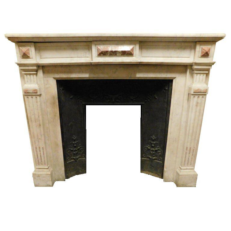 Antique Louis XVI mantel (fireplace) fireplace in white Carrara marble with pink marble inlays, built and carved by hand in the early 1800s for a historic house in France.
Very beautiful and scenographic, easy to set thanks to the geometric lines,