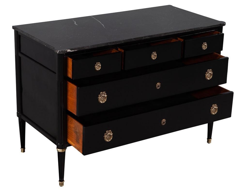 black dresser with white marble top