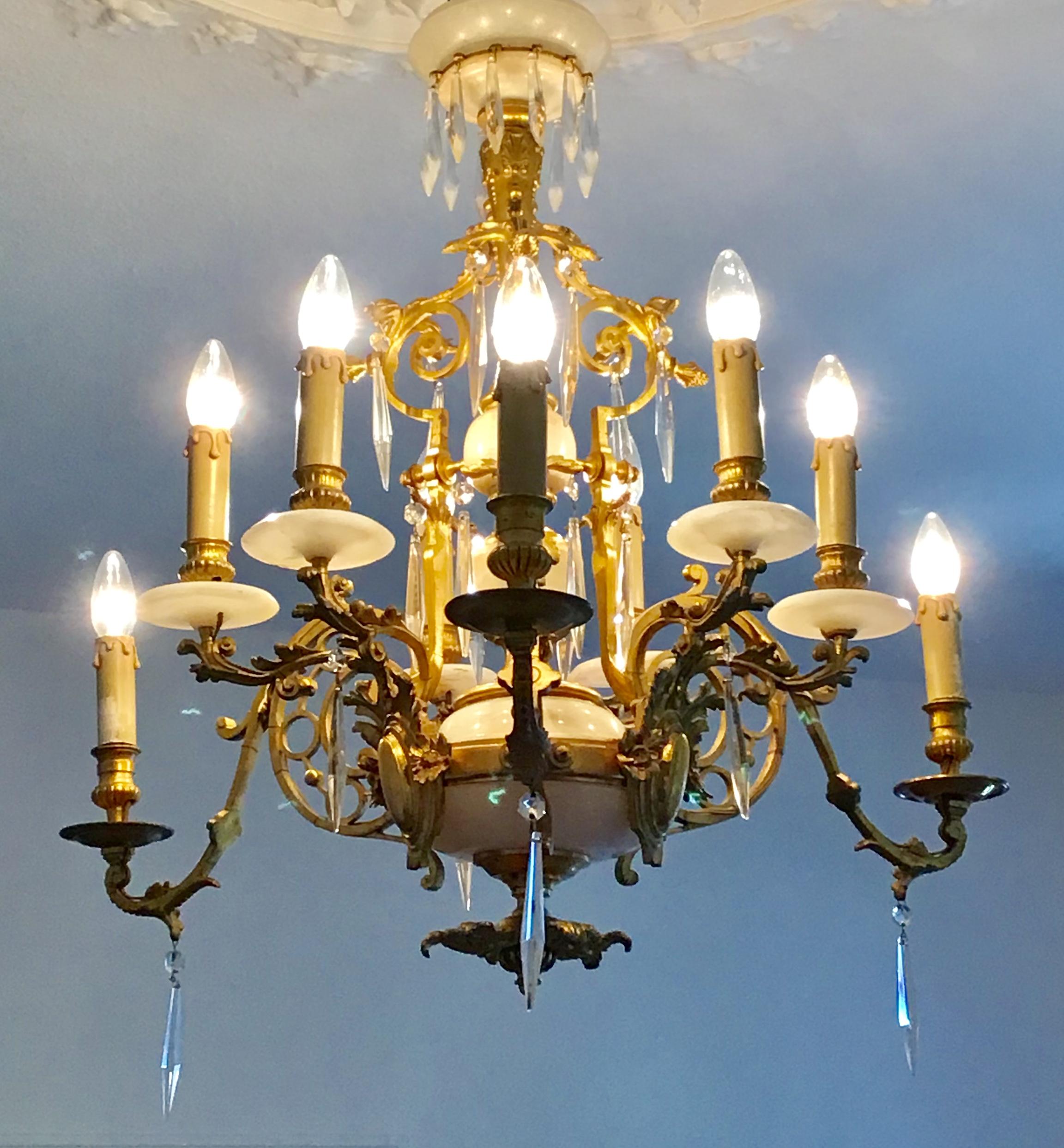 Antique, French, nine-light gilt bronze and marble chandelier in the style of Louis XVI, France circa 1850s-1880s.
This amazing chandelier is made of marble and solid gilt bronze (very rich in details) and has been electrified in the 20th for e 14