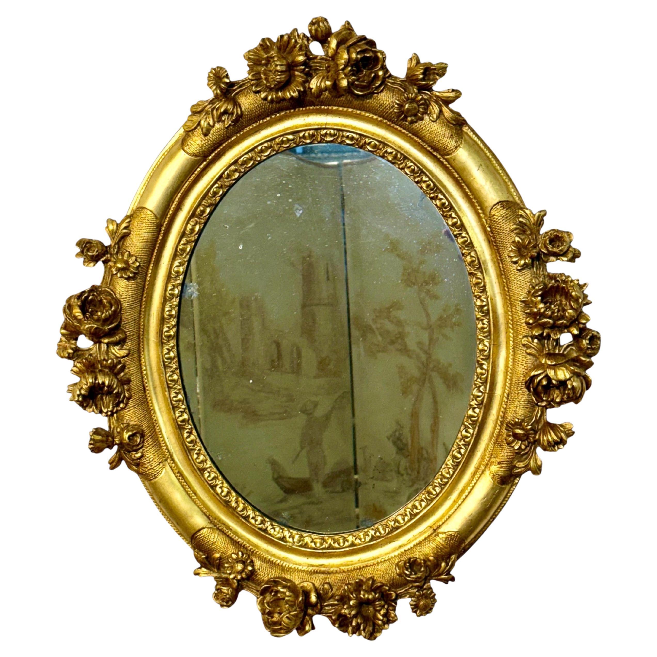French Antique Louis XVI Giltwood Oval Mirror with Floral Carving For Sale