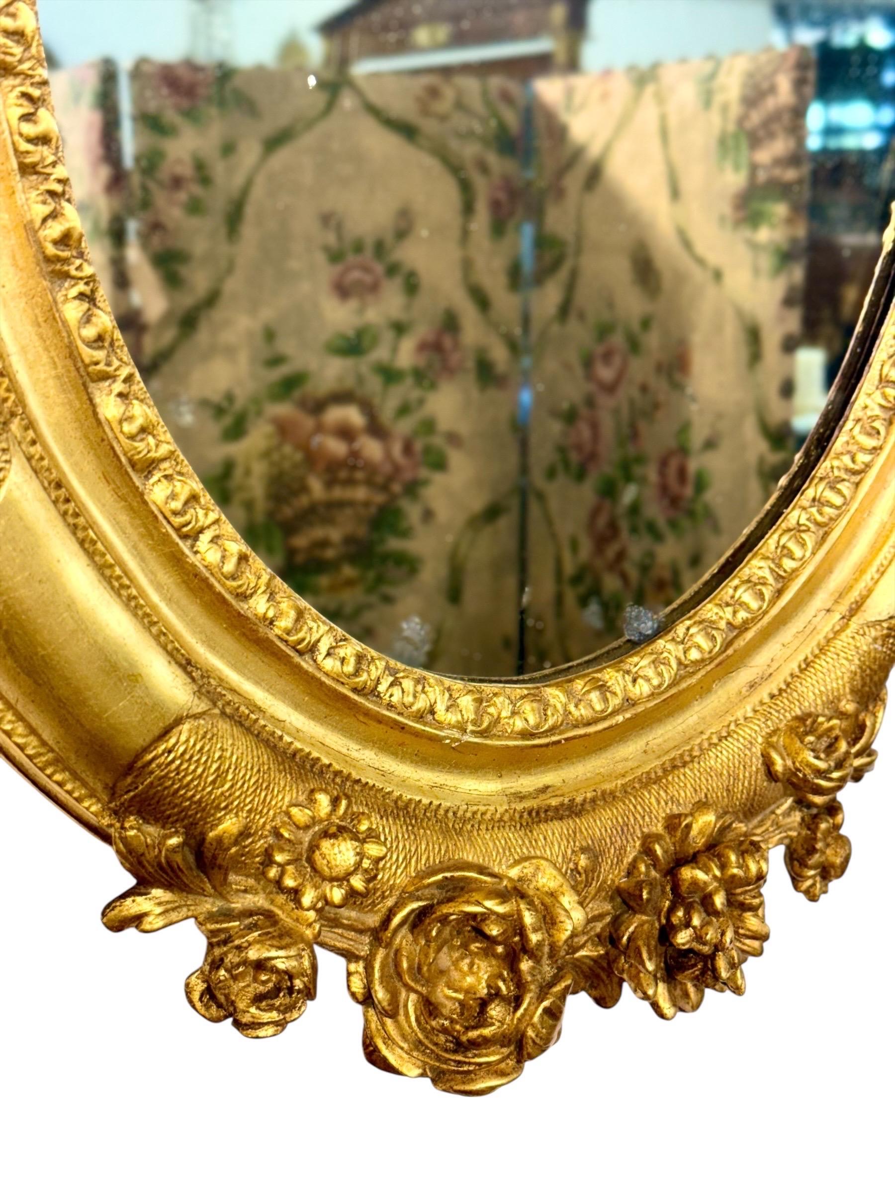 19th Century Antique Louis XVI Giltwood Oval Mirror with Floral Carving For Sale