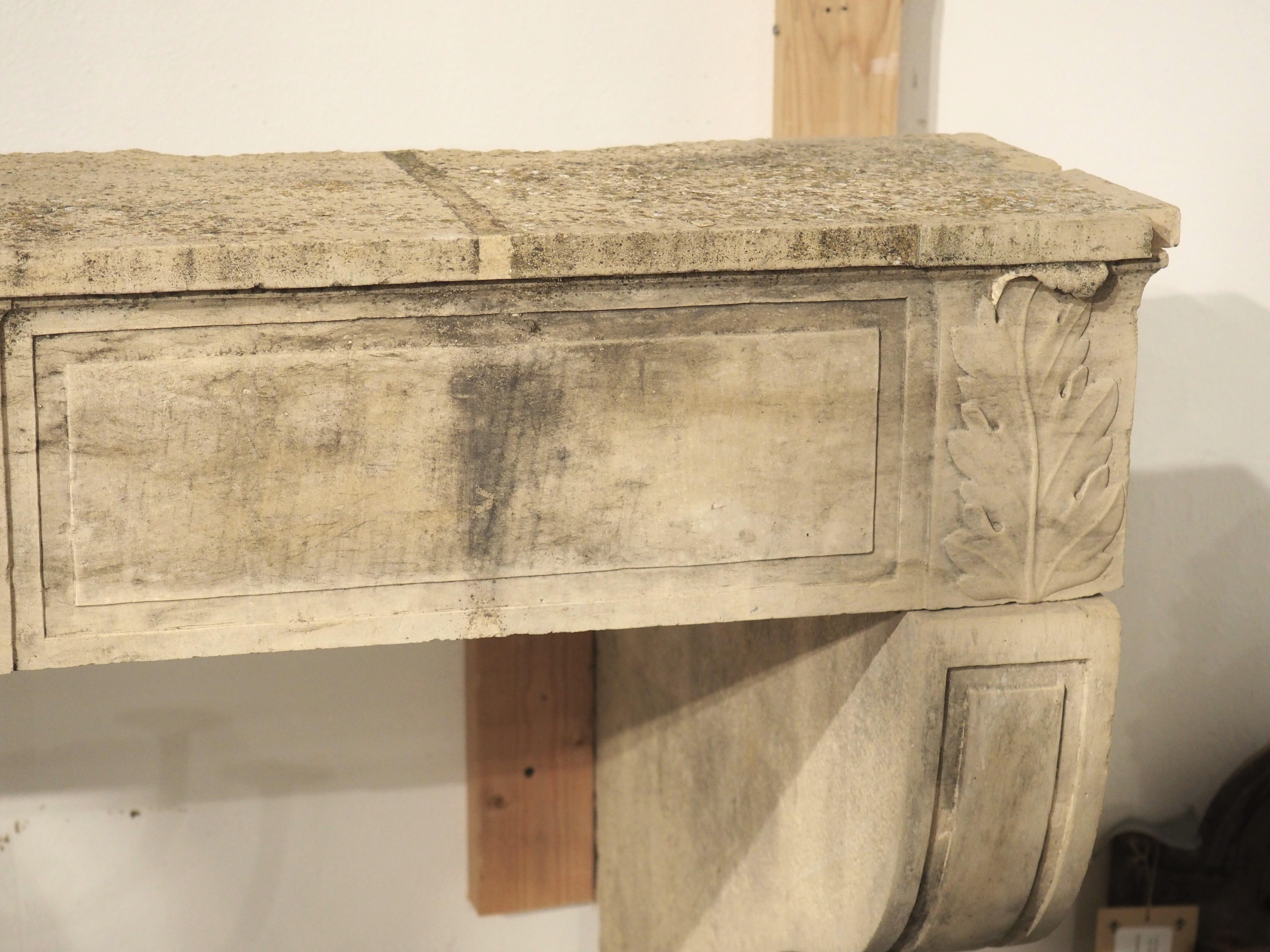 Hand-carved in five sections, this limestone fireplace mantel hails from the commune of Beaune, in eastern France. Dating to about 1785, the carvings are definitively period Louis XVI, most noticeably the center trophy medallion and the sinuous,