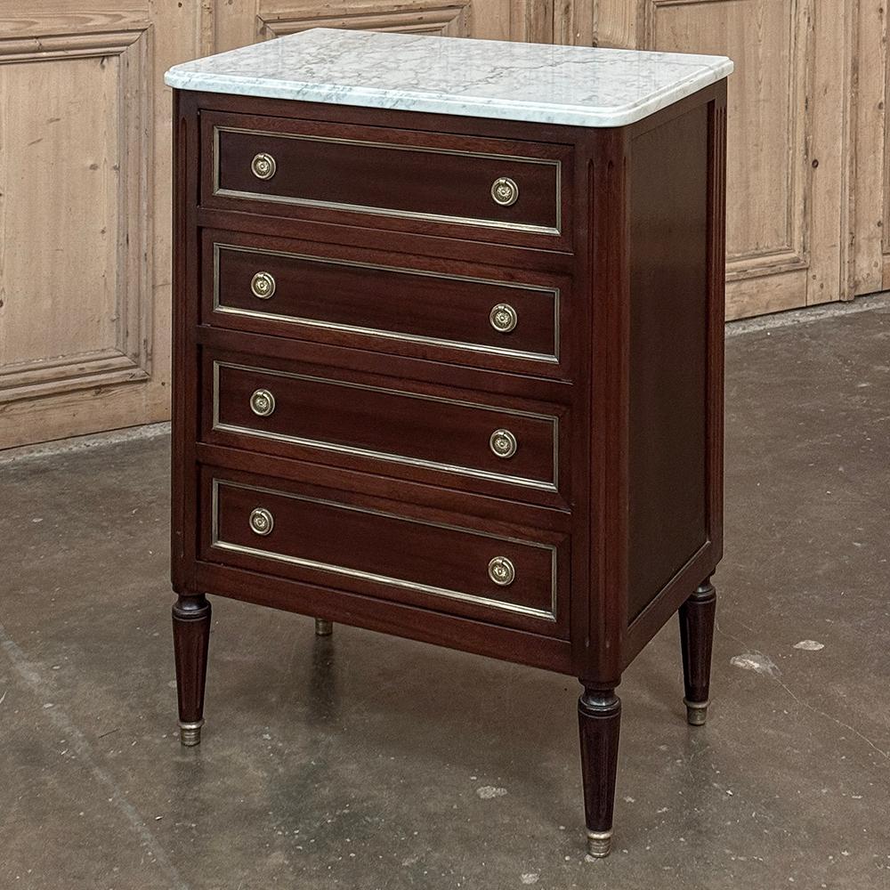 Antique Louis XVI Mahogany Chiffoniere-Petite Commode with Carrara Marble is the perfect choice for a cozy room, a special niche, between windows, or anywhere a small footprint is required.  Not only does it exude classical style that so enamored
