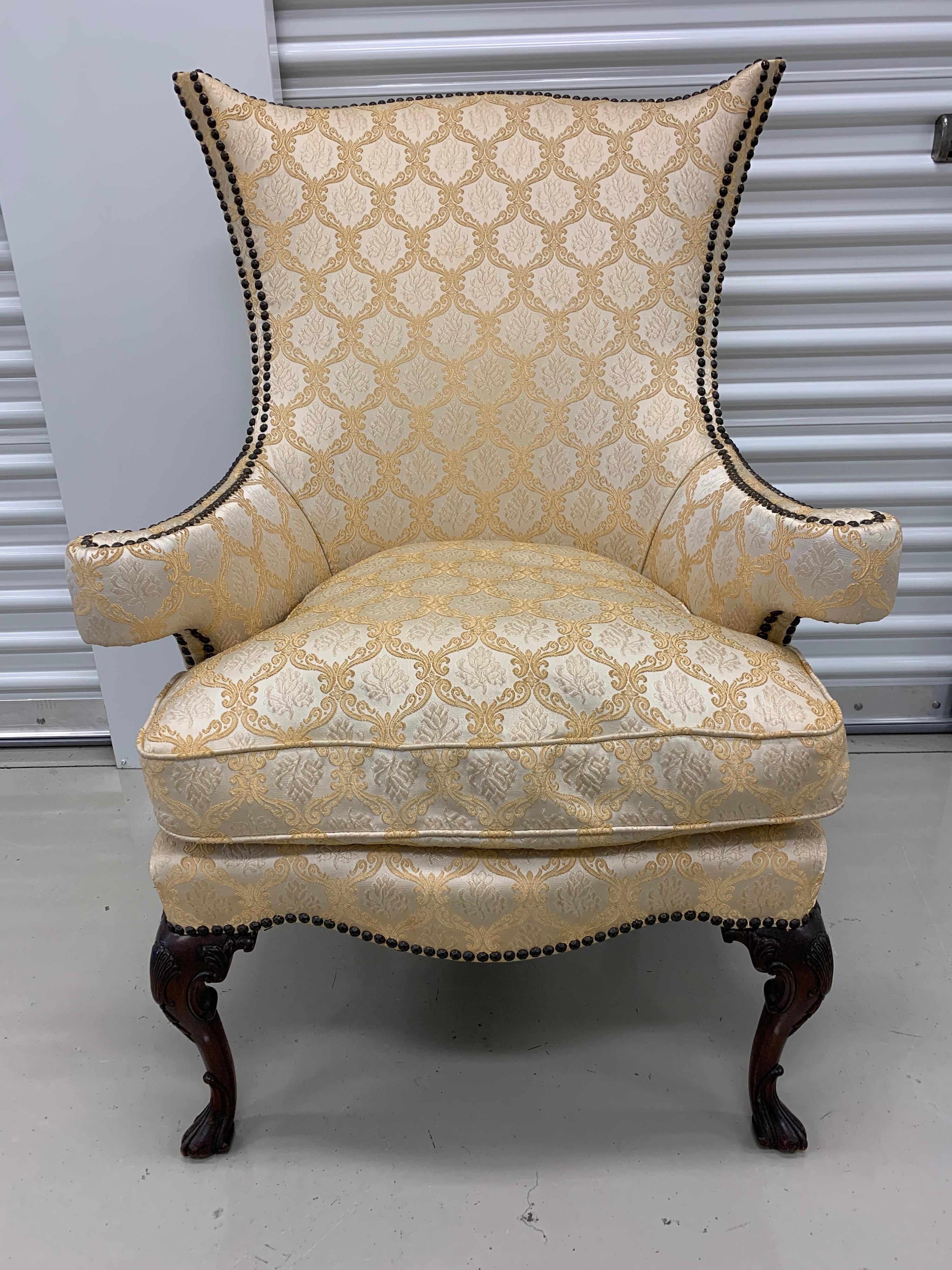 Nothing short of stunning is this Louis XVI armchair with gold and silver brocade fabric adorned by nailheads. The fabric is recent and exceptional.