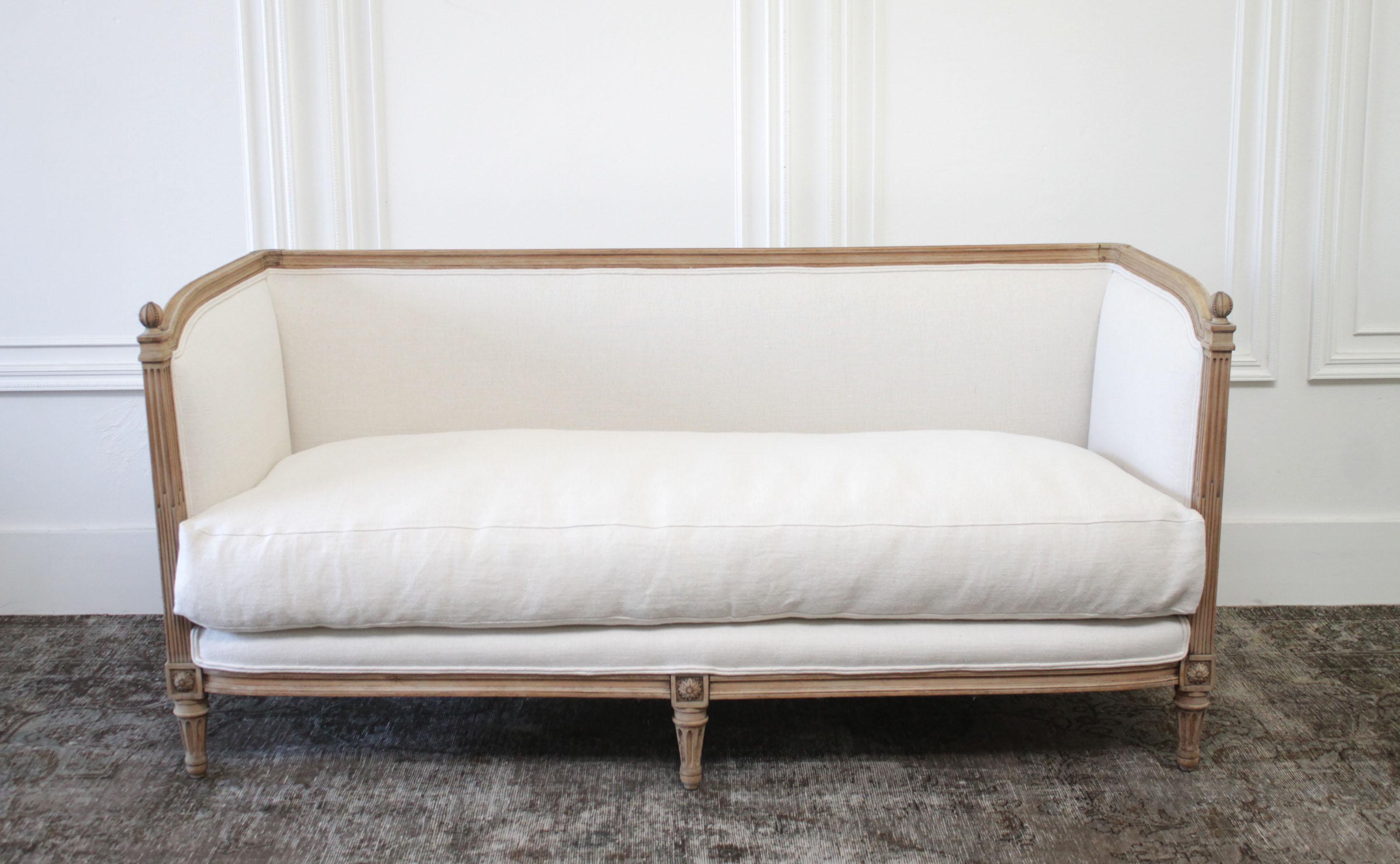 Antique Louis XVI daybed sofa bleached oak and natural linen
Beautiful raw oak and hand wire brushed finish. Upholstered in a sand heavy Irish linen with a thick nubby texture. The seat is a down wrapped foam core, very comfortable with a medium