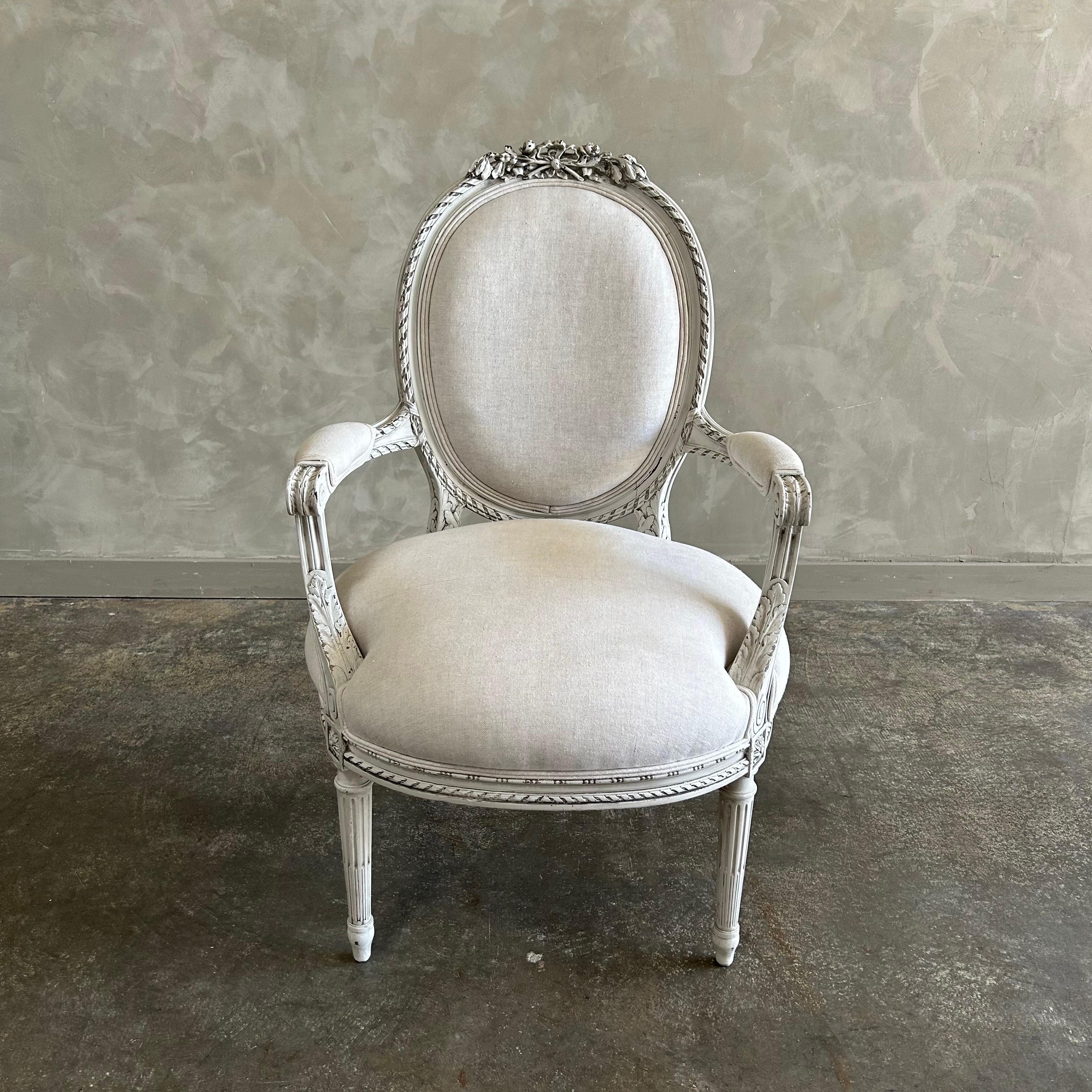 Chaise ancienne de style Louis XVI, peinte en blanc d'huître avec des bords subtilement abîmés, patinée à l'ancienne. Assise et dossier rembourrés dans un luxueux lin naturel, solide et robuste, prêt pour un usage quotidien. 
Dimensions : 24 