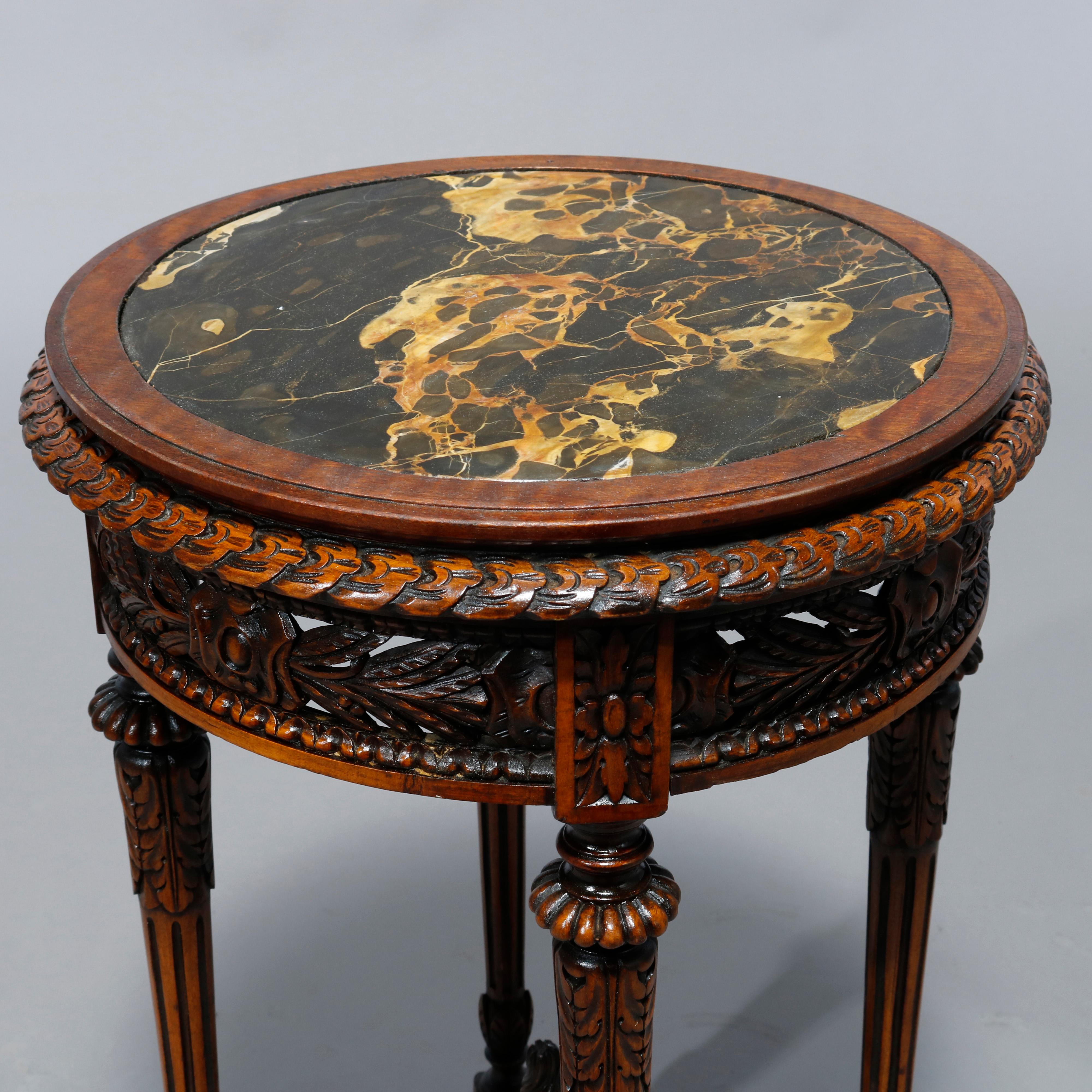 An antique French Louis XVI style Belgian drink stand offers inset marble top over mahogany base having carved and pierced foliate skirt raised on reeded tapered legs having deeply carved stretcher with central urn form finial, c1900

Measures: