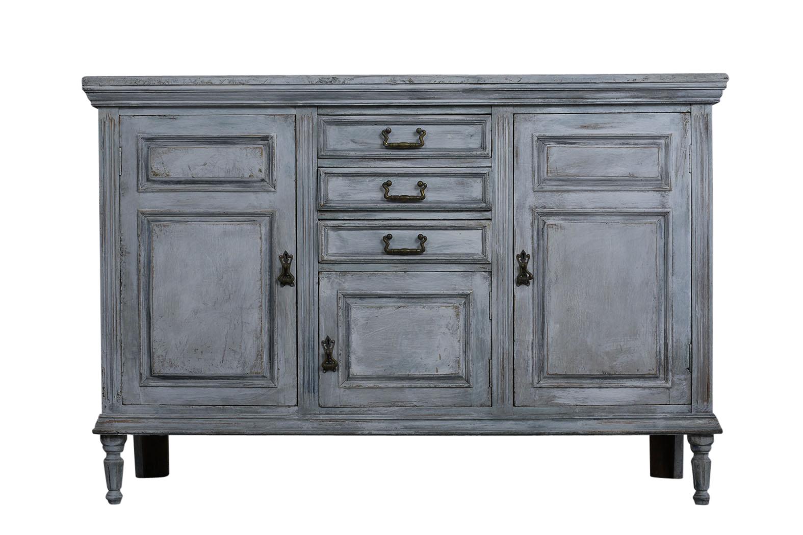This 1900s Louis XVI-style Buffet is made from maple wood painted in a white and grey-blue color combination with a distressed finish. There are three center drawers with brass drawer handles, a small panel door with a compartment underneath, and
