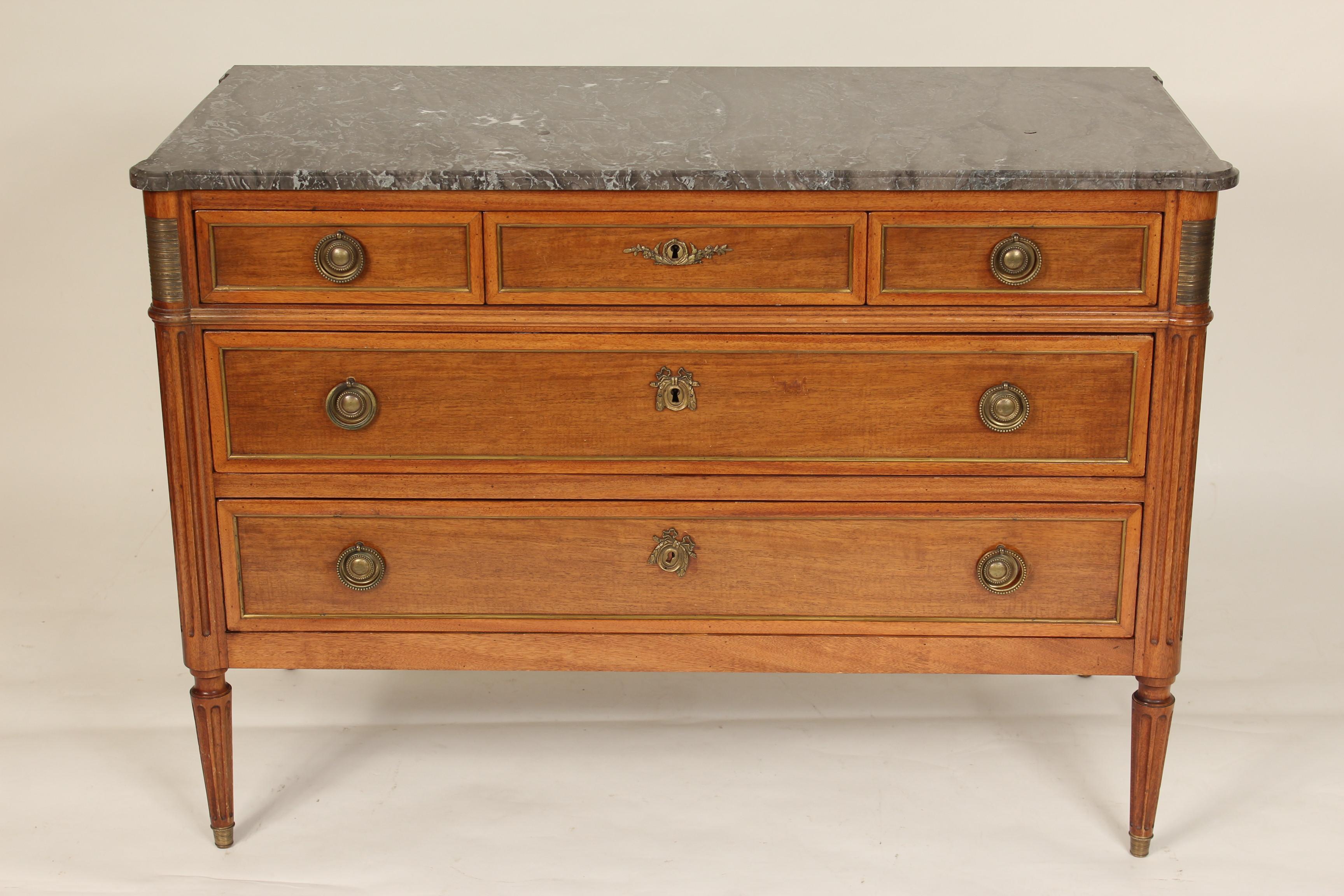 Antique Louis XVI style mahogany chest of drawers with brass moldings, mounts and a hand cut marble top, late 19th century.