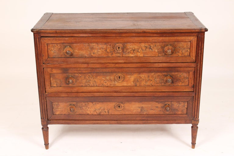 Antique Louis XVI style walnut chest of drawers with burl elm drawer panels, 19th century.