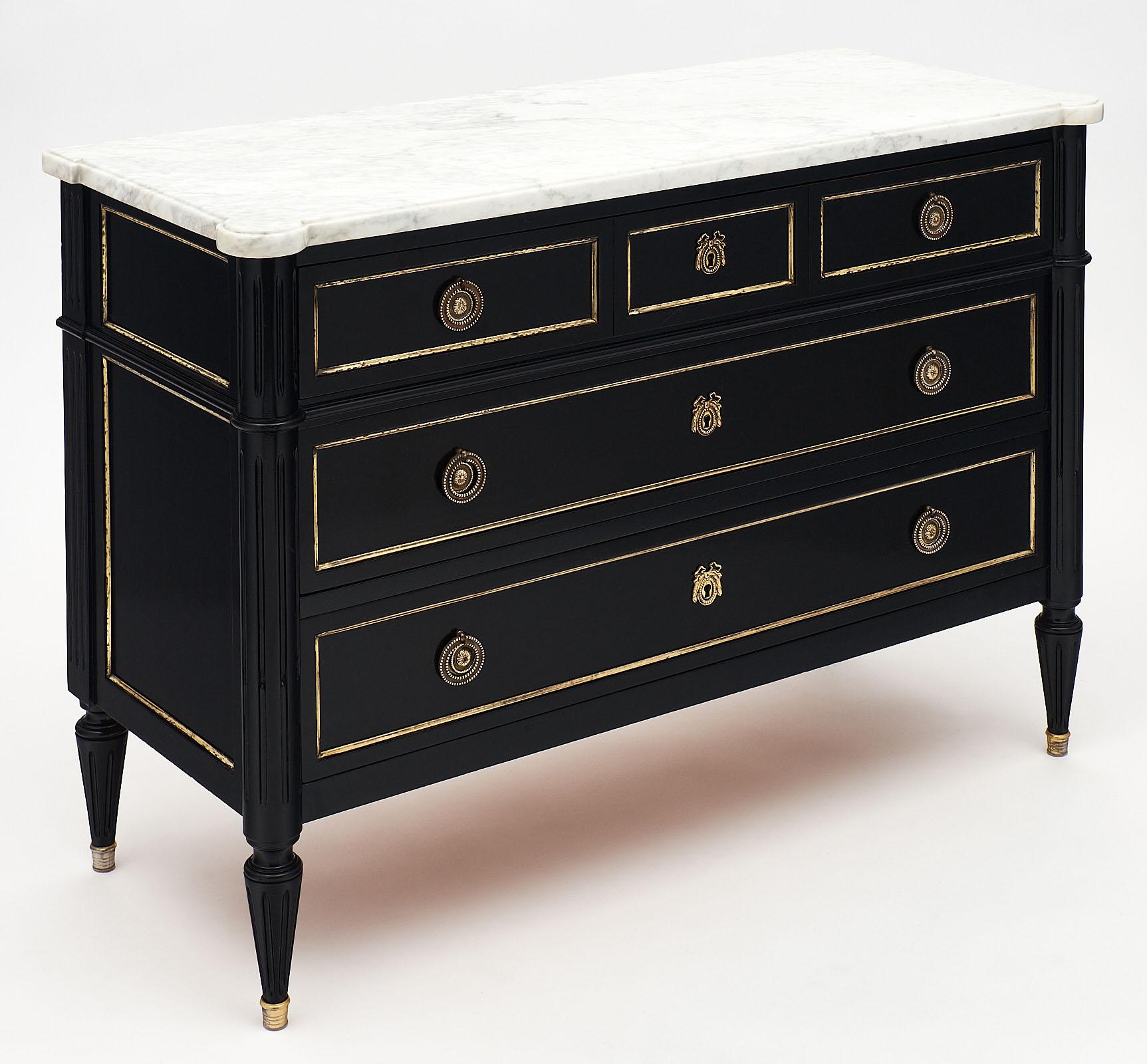 Louis XVI style French antique chest with original Carrara marble top. This piece features brass hardware and trim throughout. It is made of solid mahogany and ebonized with a lustrous French polish finish. We love this classic piece!