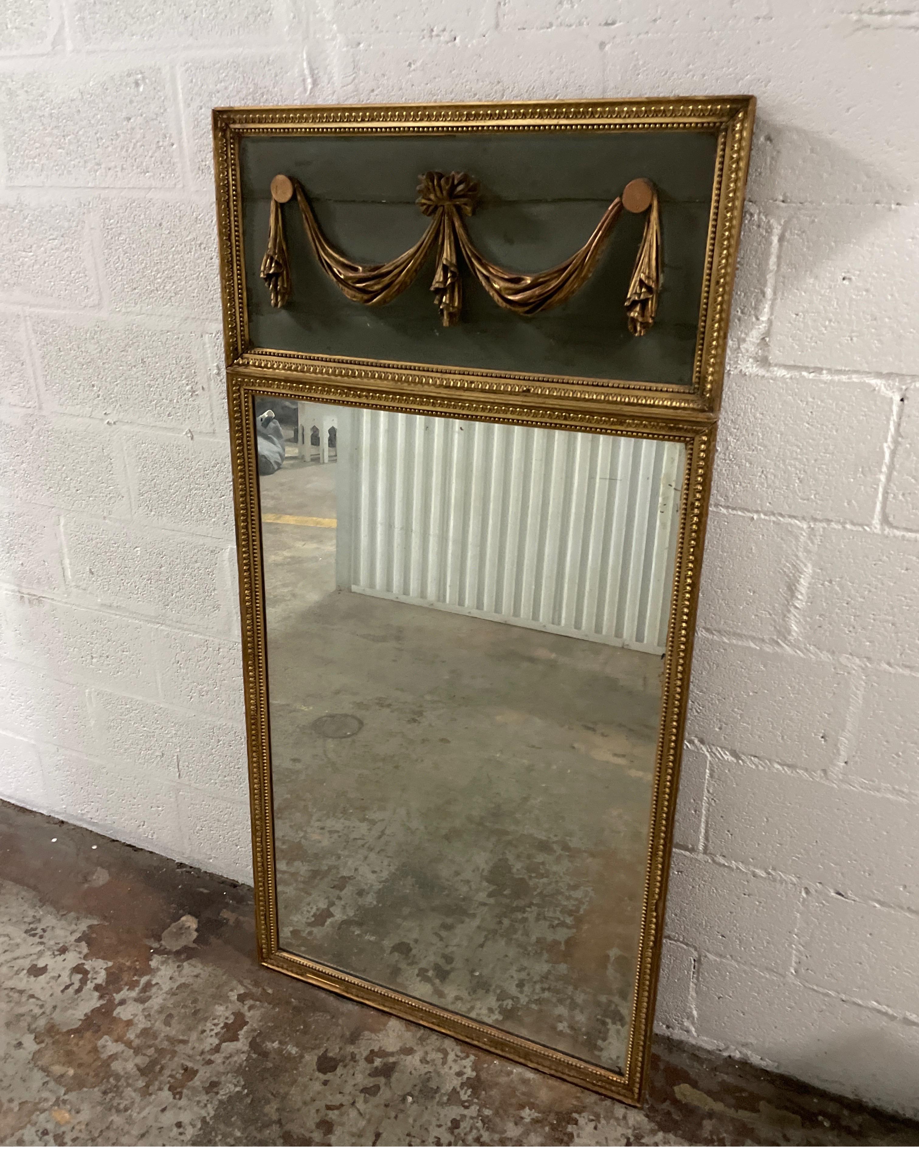 19th century painted & gilded french Louis XVI style trumeau mirror with carved swag pediment. The mirror plate is original to the piece.