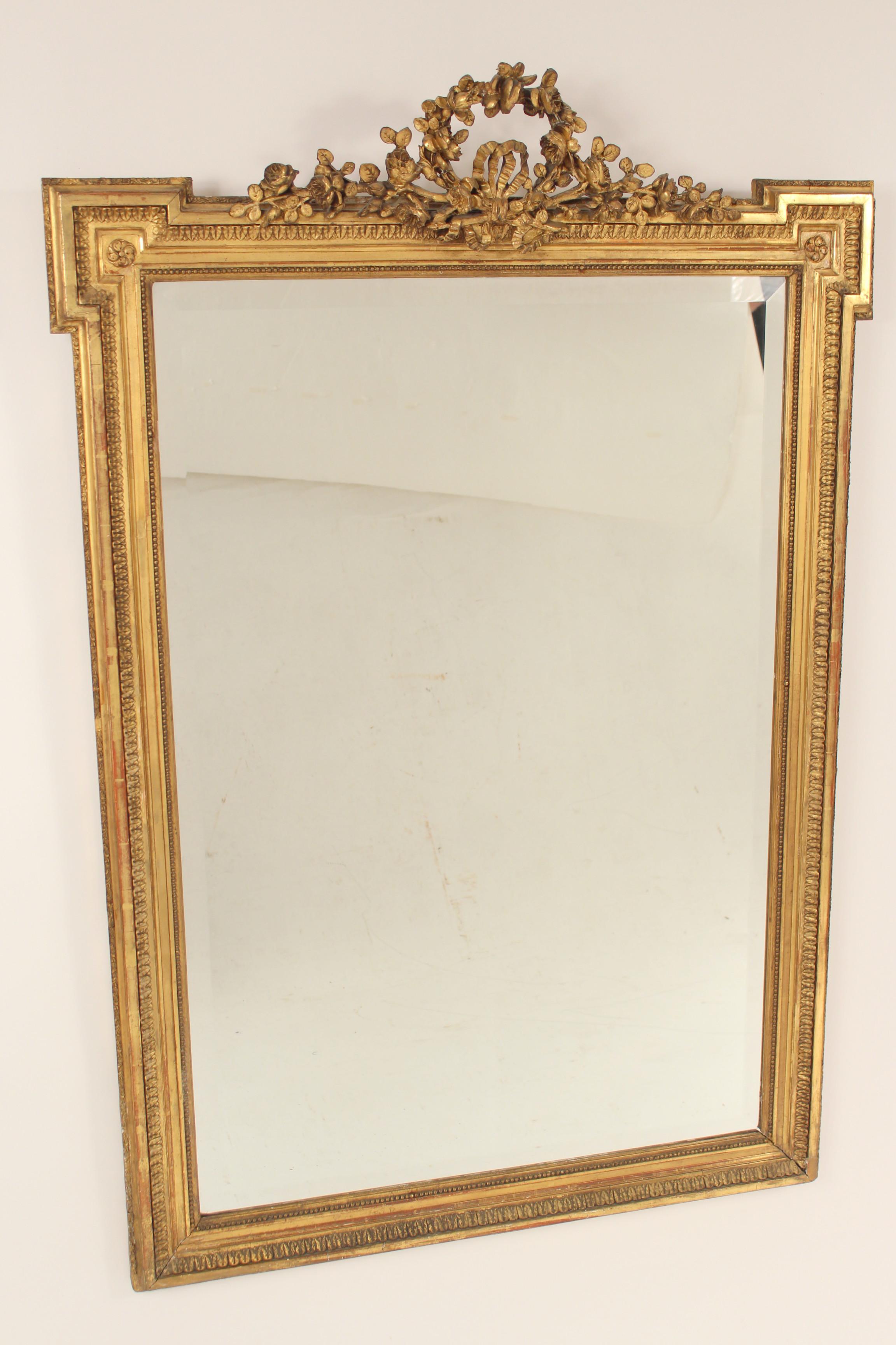 Antique Louis XVI style gilt wood and gesso mirror, circa 1900. The gilding on this mirror is gold leaf.