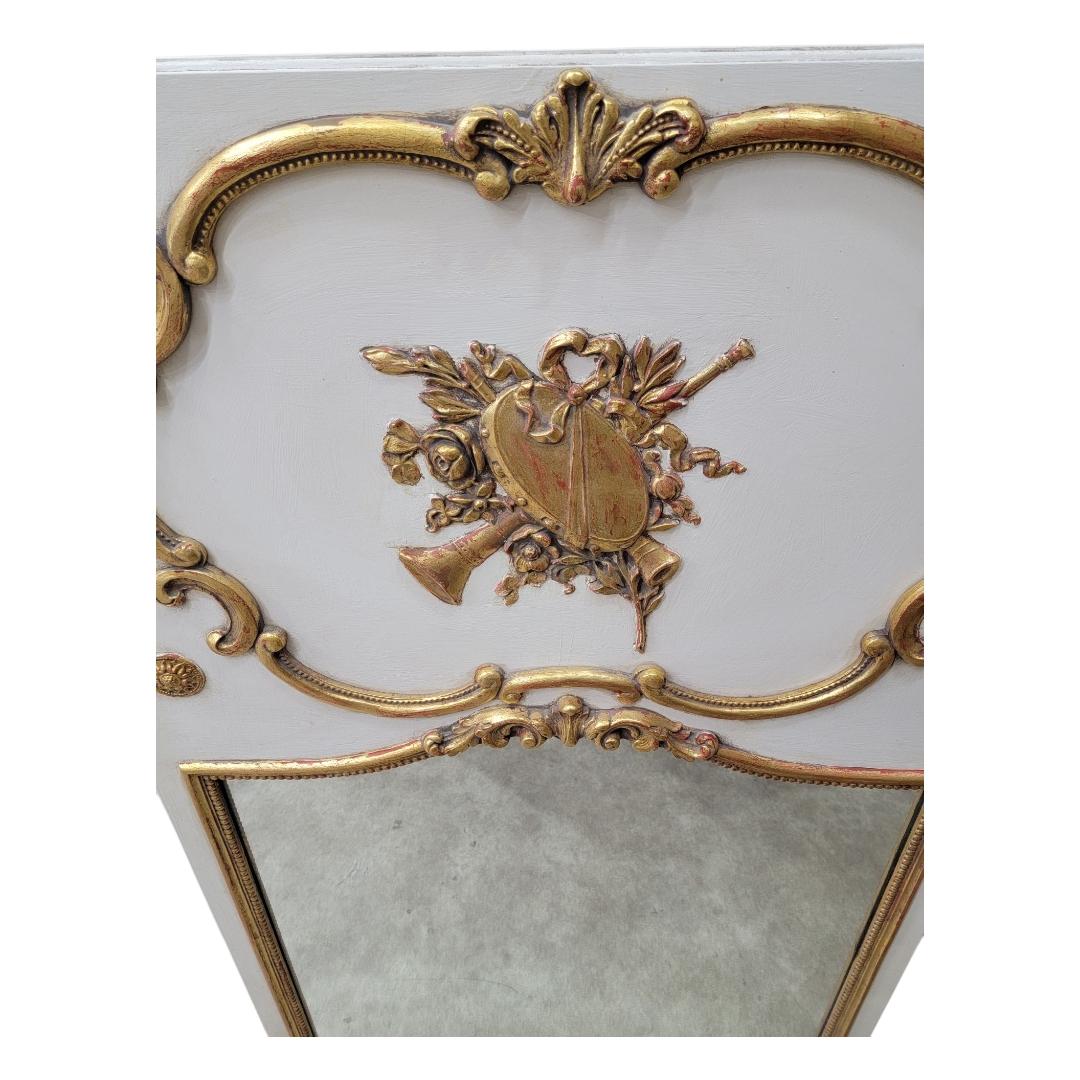 Antique Louis XVI Style Carved Gold Gilded & White Painted French Trumeau Wall Mirror

Perfect for enhancing natural light and creating an illusion of space, this mirror is not just a functional item but a statement piece that embodies the grandeur