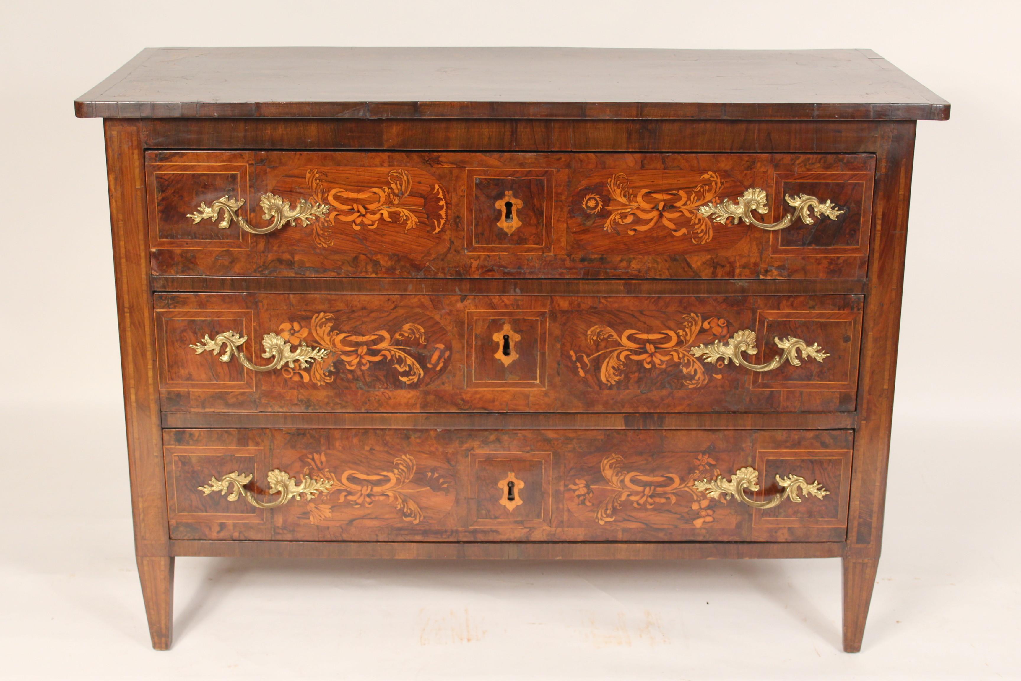 Continental antique Louis XVI style floral inlaid walnut chest of drawers with brass hardware, 19th century.