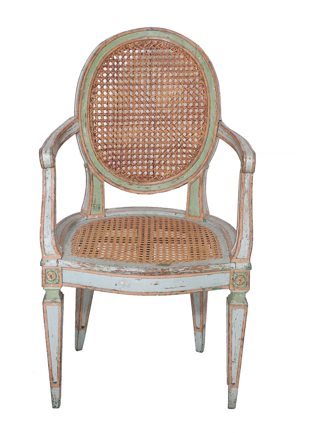 These antique caned Italian armchairs are beautifully proportioned with lovely painted finish and caned back and seats. These antique Louis XVI style Italian caned armchairs are a terrific addition as host chairs to a dining table or sitting