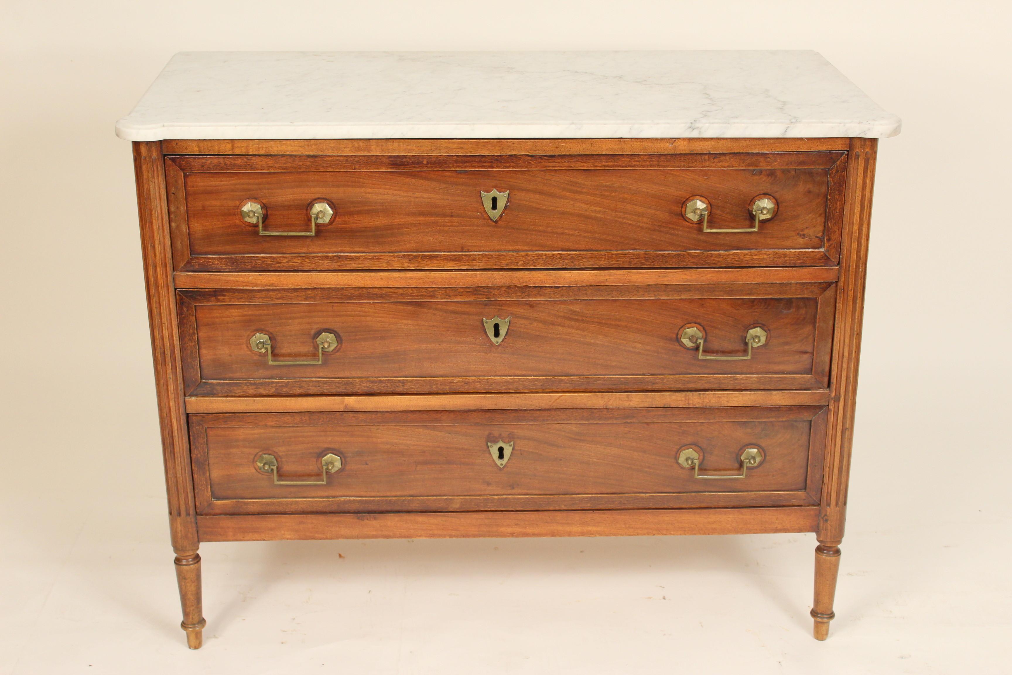 Antique Louis XVI style mahogany chest of drawers with marble top and brass hardware, late 19th century.