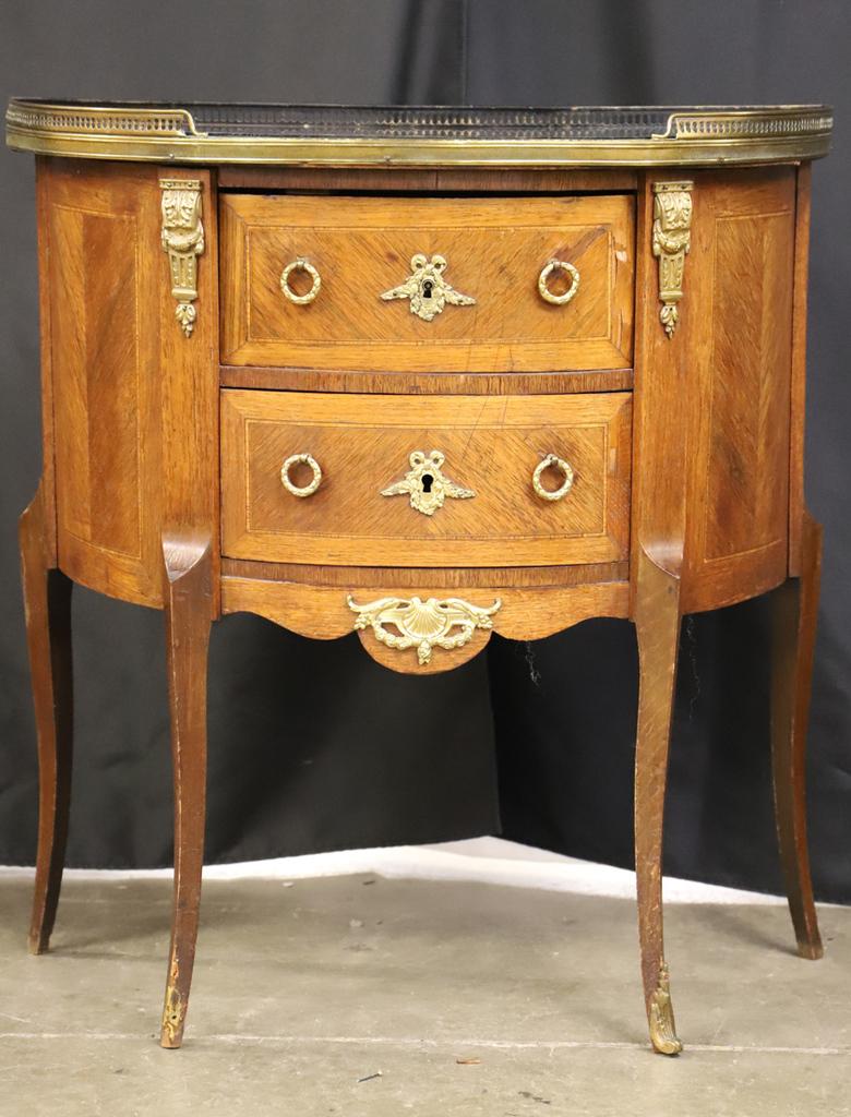 Antique Louis XVI Style Demilune Table With Glass Top and Gallery. The brass galleried glass demilune top upon a corresponding case with an ormolu decorated center drawer flanked by side drawers over a galleried shelf on squared tapered legs with
