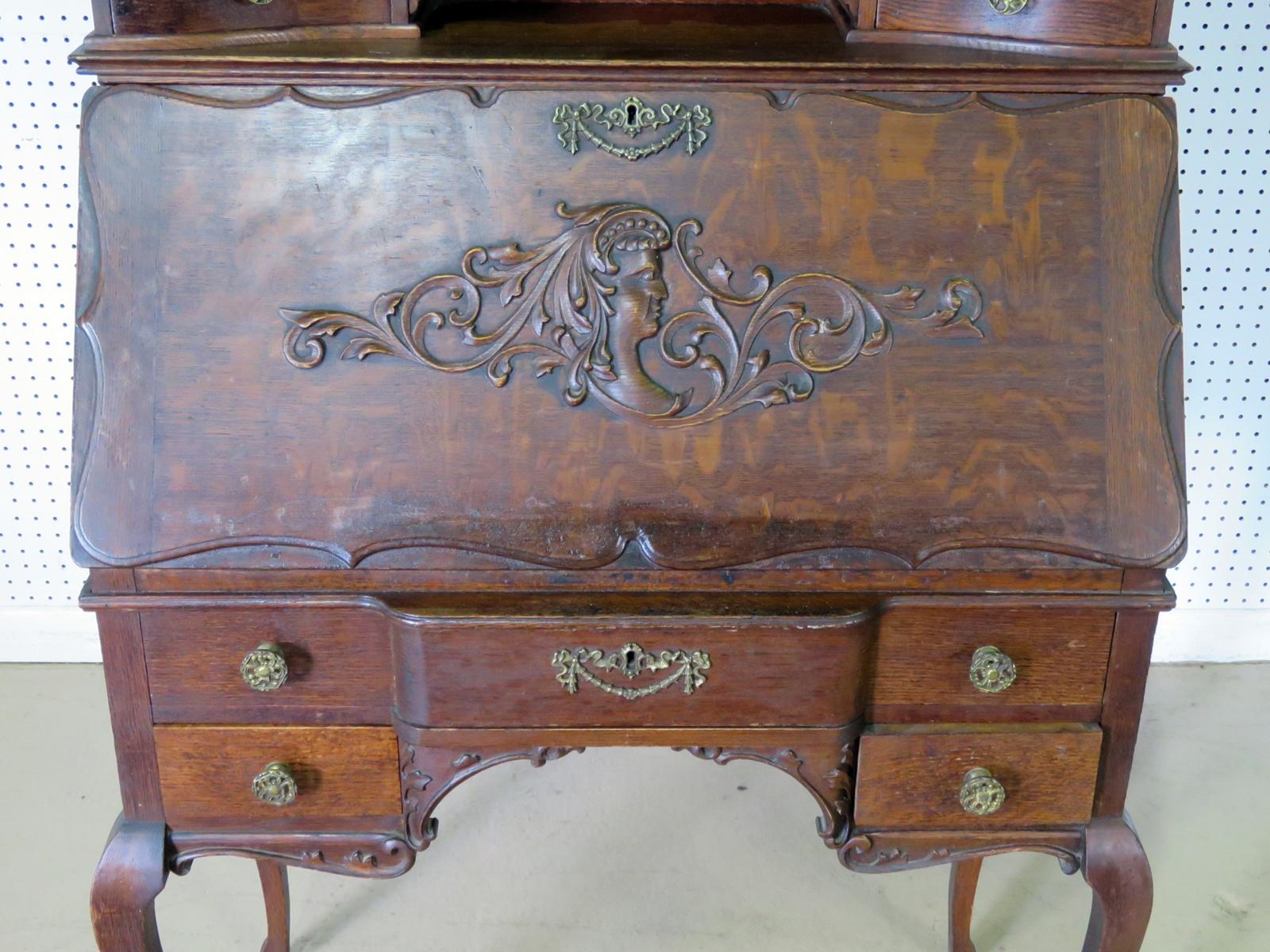 Antique quarter-sawn oak secretary desk with a beveled mirror backsplash and brass accents.