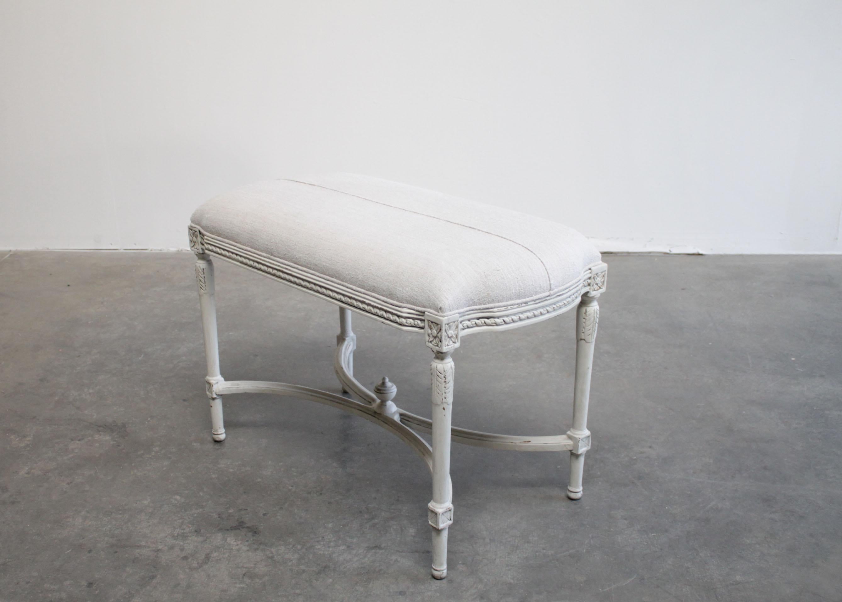 Antique Louis XVI style upholstered high bench ottoman with antique linen
Beautiful frame painted in a soft oyster white, with subtle distressed edges, and glazed finish.
We upholstered this in a beautiful antique European homespun nubby linen in