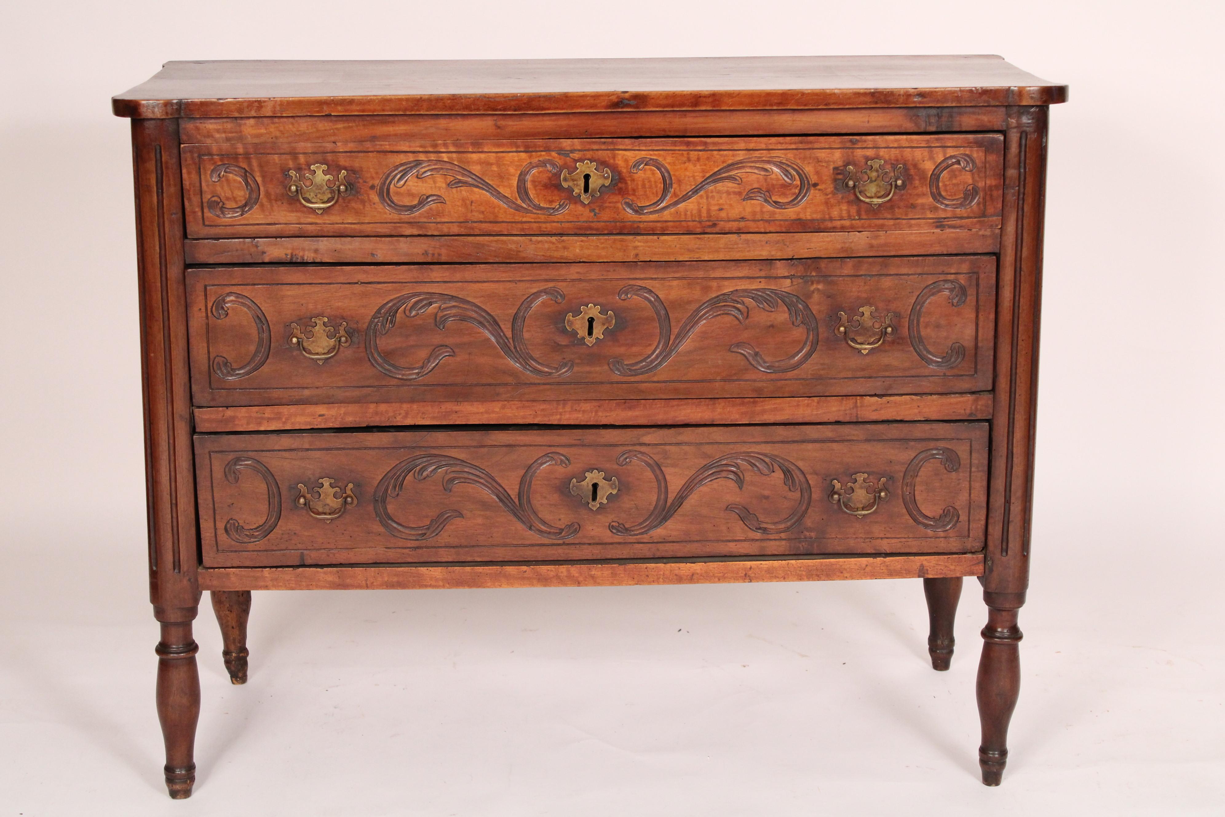 Antique Louis XVI style walnut chest of drawers, 19th century. With a single board walnut top with turret front corners, 3 walnut drawers each with incised designs, resting on turned legs. Hand dovetailed drawer construction.
