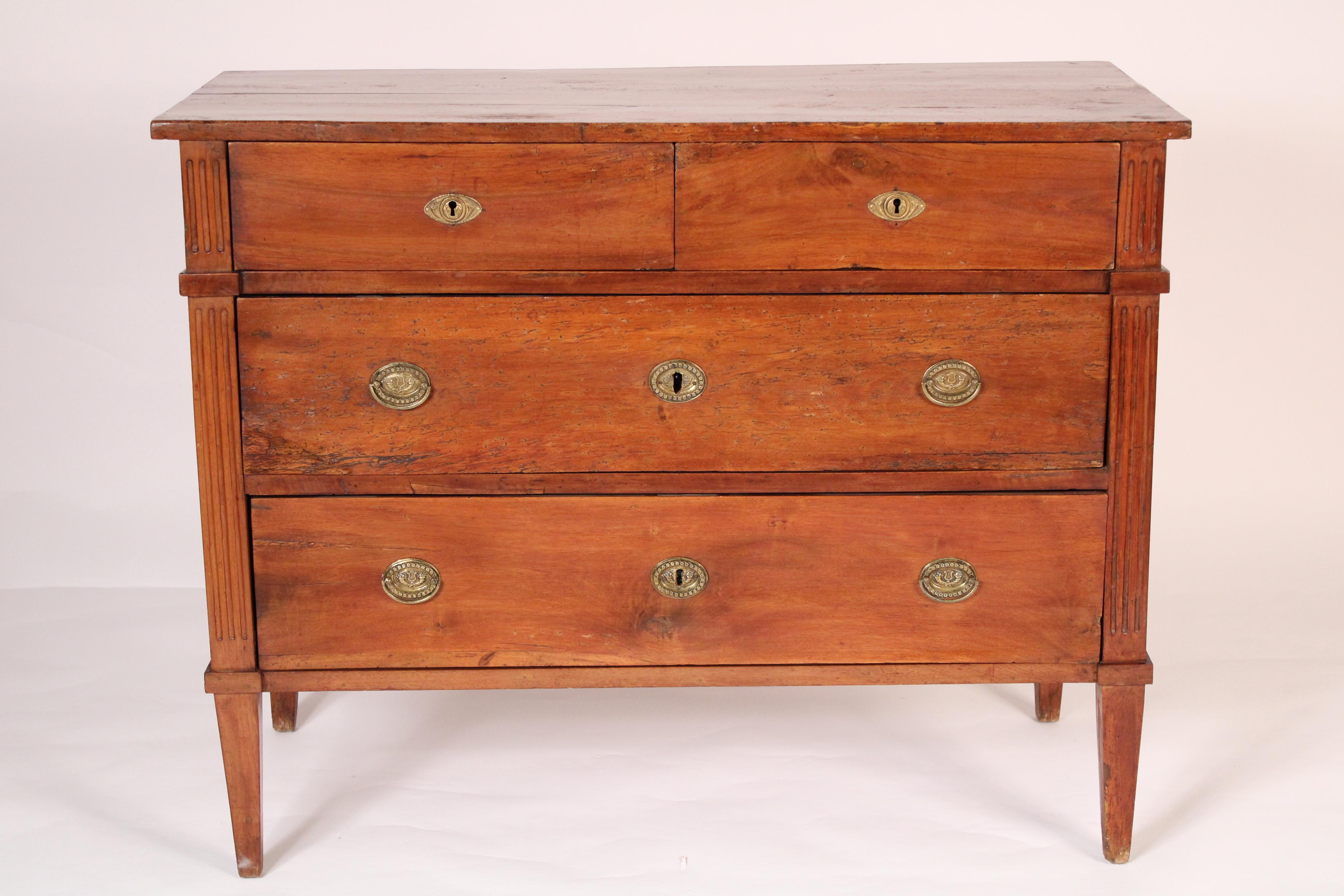 Antique Louis XVI style walnut chest of drawers, 19th century. With a 3 board rectangular top, two top drawers and two lower drawers flanked by fluted stiles, resting on square tapered legs. Nice color. Hand dovetailed drawer construction.