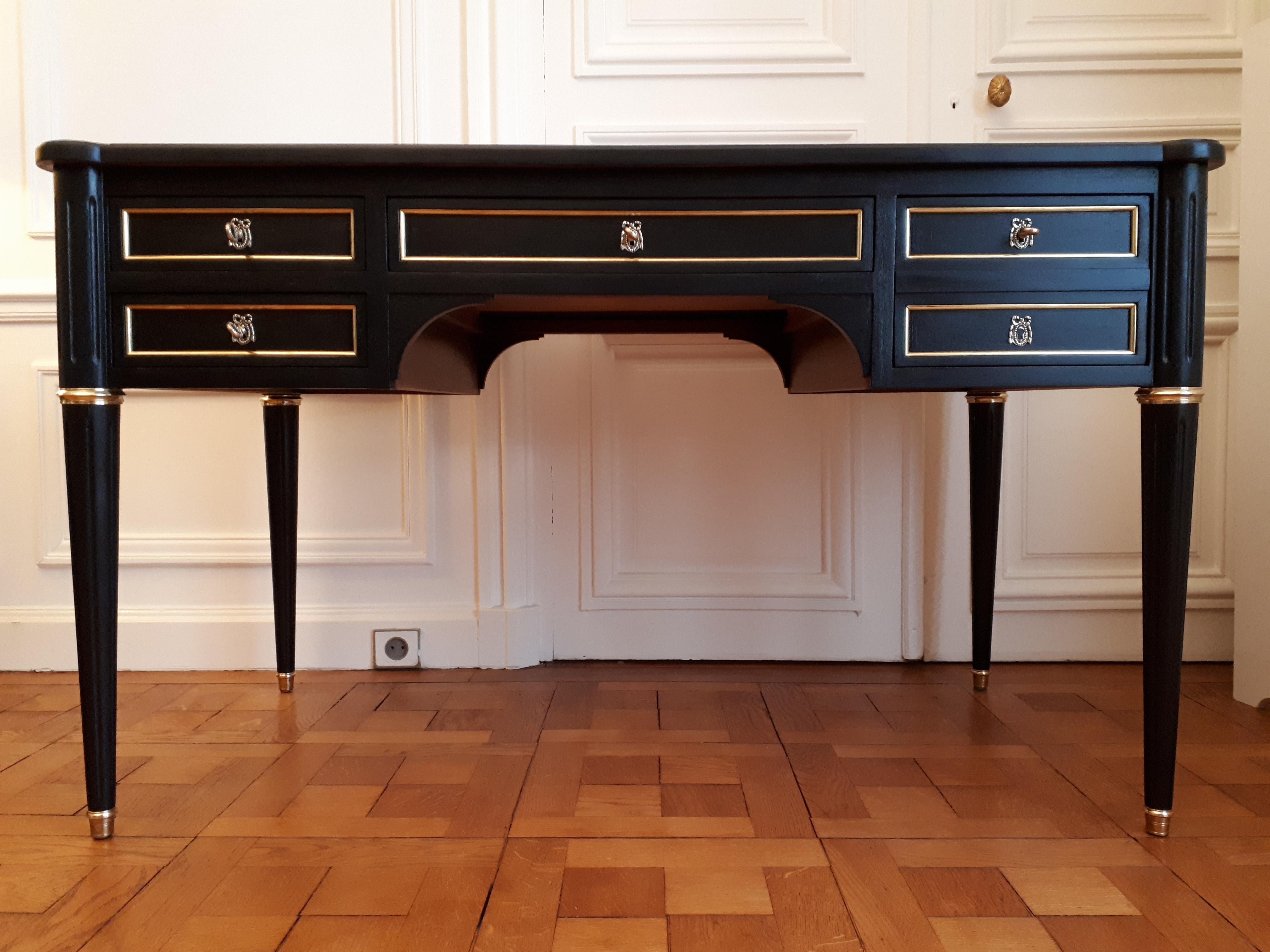 Antique Louis XVI style desk with cognac leather top and gold embossed frieze.
The front of the piece has four dovetail drawers with brass trim. The right double drawer is actually a single deep drawer with a secret hiding place in the double