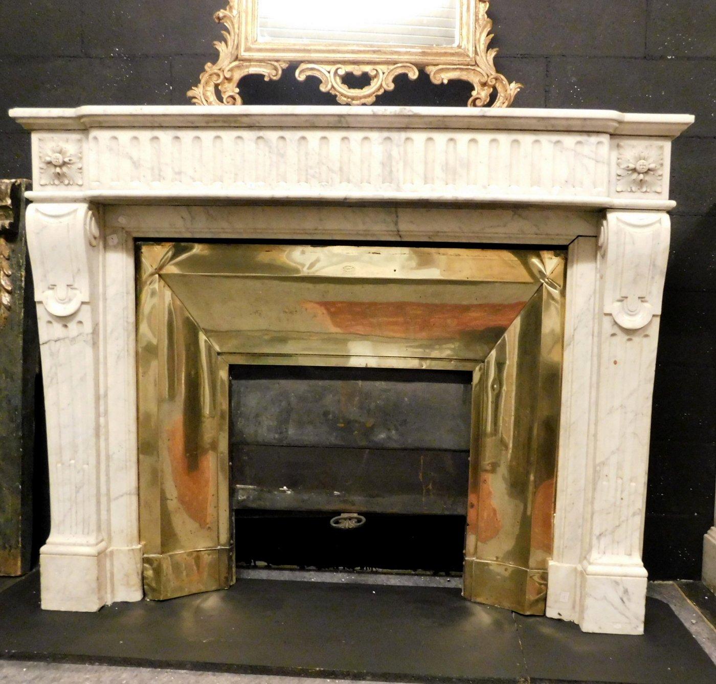 Antique Louis XVI white marble fireplace, hand carved with typical period flowers and sculptures on the uprights, sold with original brass counter-heart (no front wings and fireplace decorations), handmade in the late 18th century in France, it came