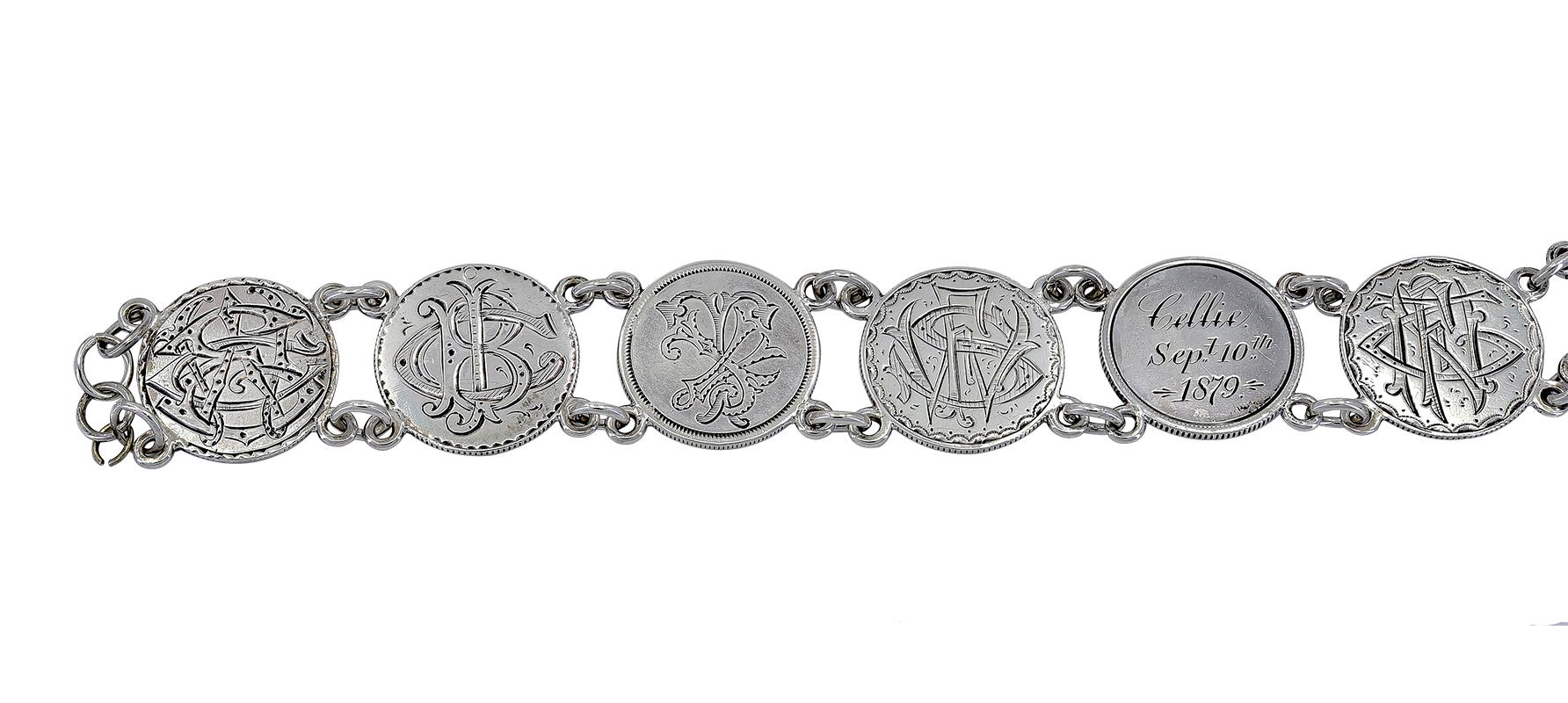 Lovely and romantic antique bracelet,.  Comprised of eight silver dimes picturing Lady Liberty, dating from 1874 to 1878.  These dimes were considered love tokens because of the intricate intertwined initials on the reverse side.  Sterling silver