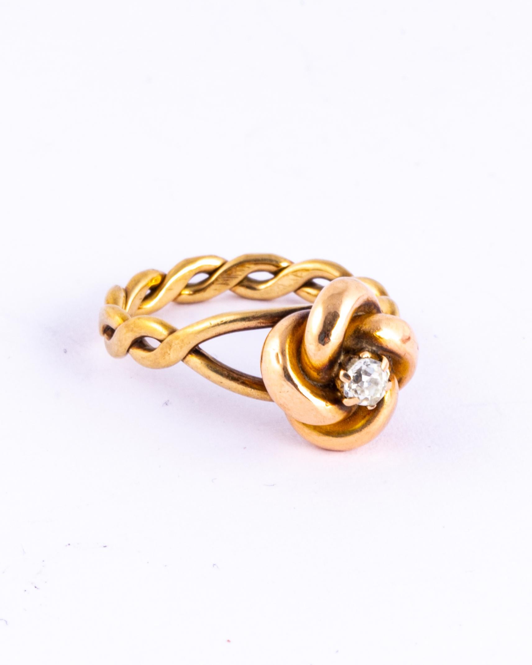 This gorgeous and chunky lovers knot ring hold a diamond at the centre. The knot sits up high on the twisted band and is beautifully glossy. Modelled in 15ct gold. The diamond measures 15pts and is old mine cut. 

Ring Size: K 1/2 or 5 1/2 
Height