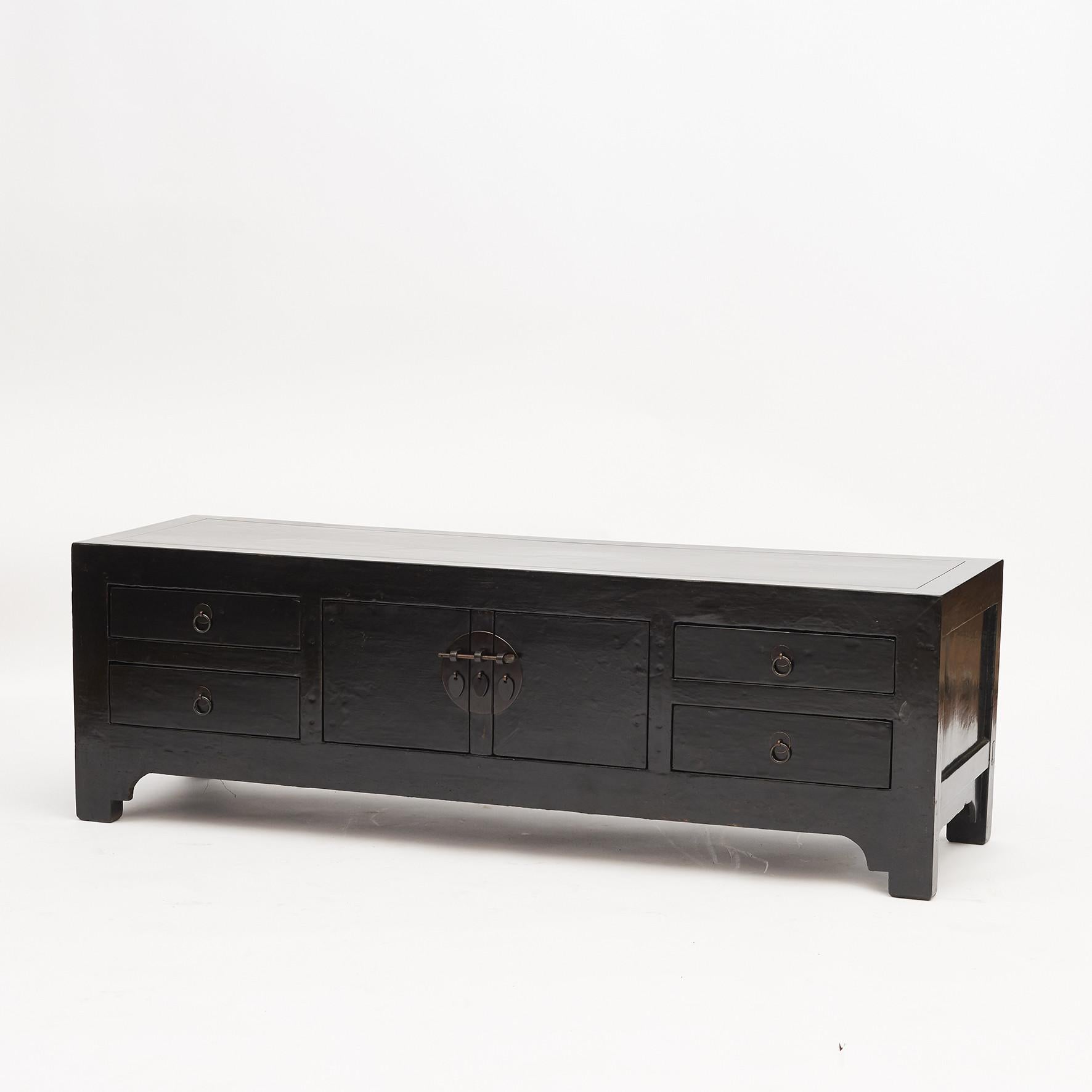 Low Kang cabinet with sets of double doors and four drawers. Each drawer is adorned with brass ring pulls with circular back plates.
Suitable as TV table. Good craftsmanship.
Hebei Province, China, 1880-1900.
  