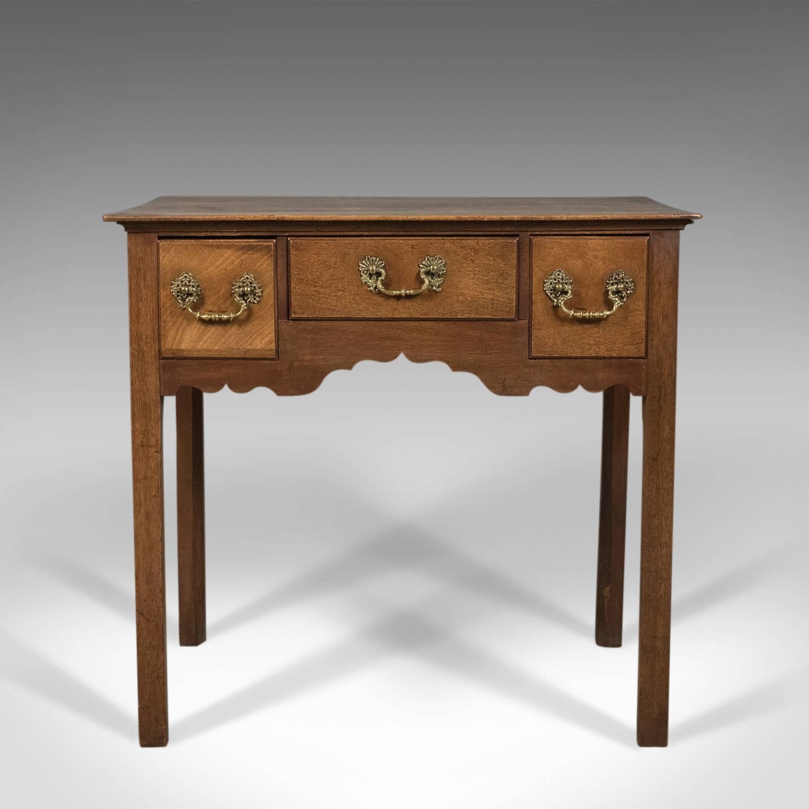 This is an antique lowboy, a mahogany, English, Victorian side table dating to circa 1900 in the Georgian taste.

Grain interest and desirable color to the attractive light mahogany
Lustrous shine to the wax polished finish
Raised on square
