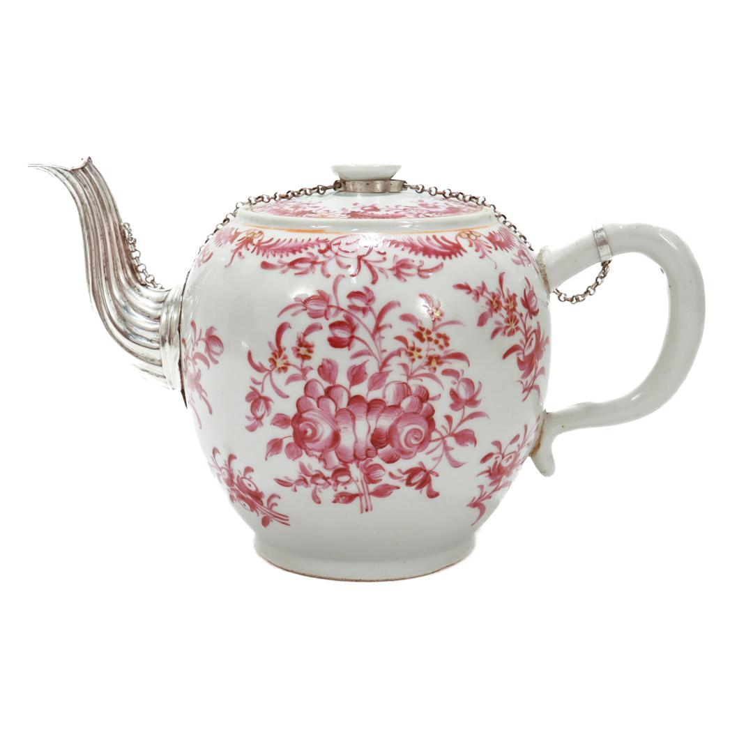 A fine Chinese export porcelain teapot.

With pink painted floral decoration throughout.

The original spout has been replaced with a make-do fluted silver metal spout.

There is an associated safety chain that connects the lid to both handle and