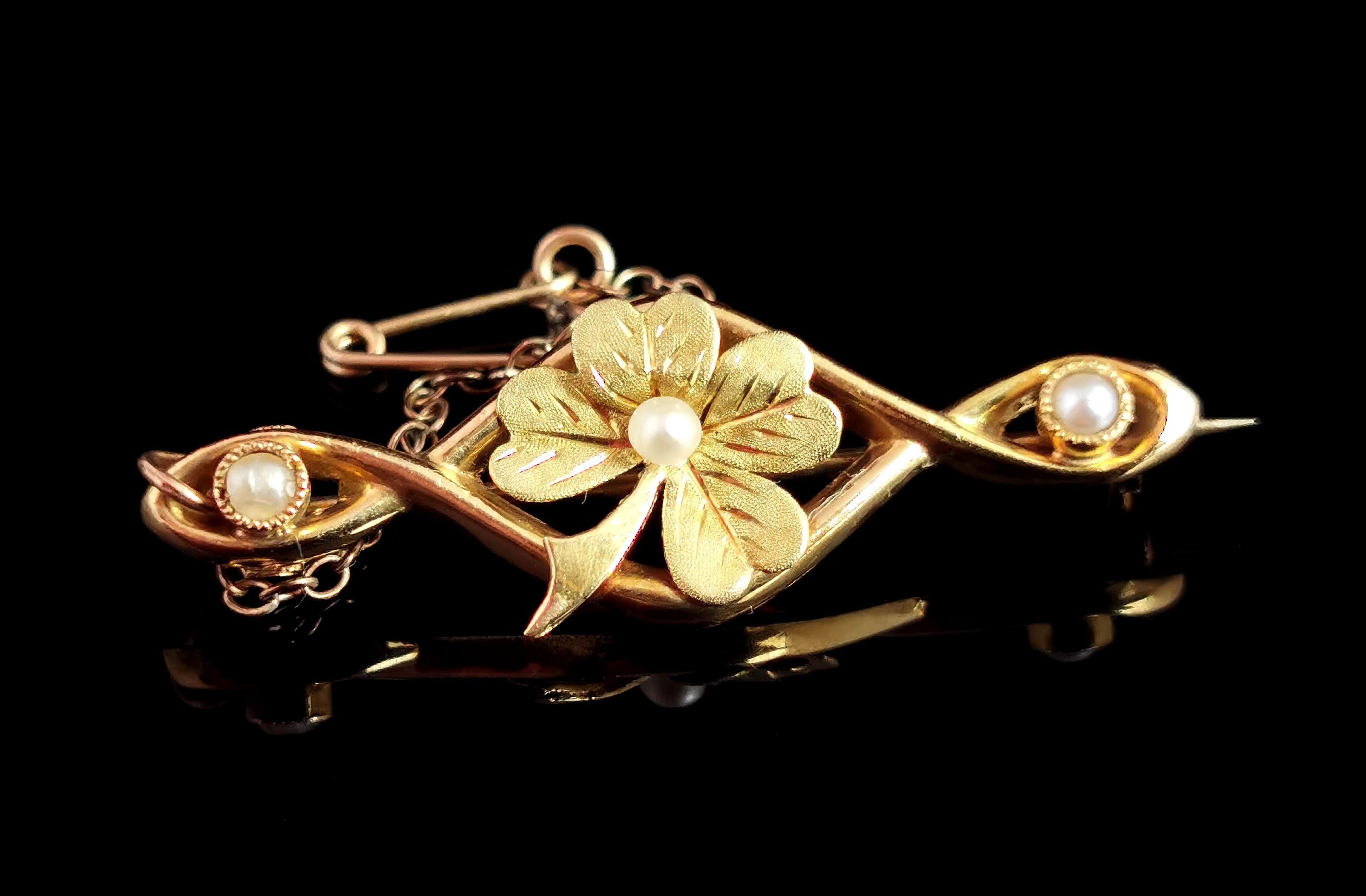 A very pretty antique, 9kt gold, seed pearl lucky shamrock or clover brooch.

A beautiful rich 9kt yellow gold Crossover bar brooch with twist detailing.

The centre features a textured four leaf shamrock or clover set with a single seed pearl to