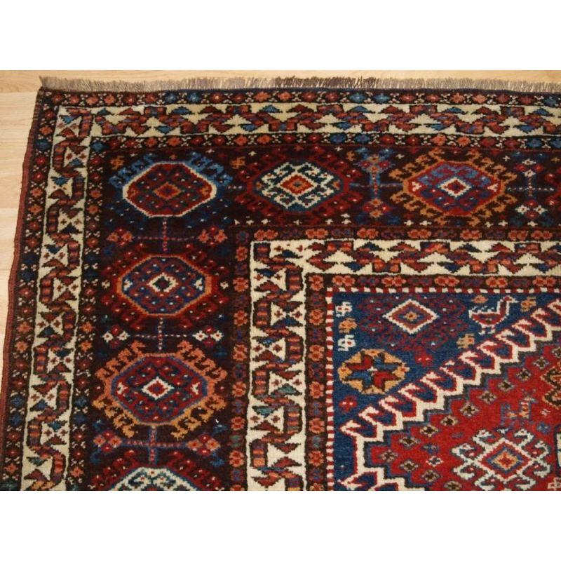 This rug is an excellent example of Luri tribal weaving, with a field of four latch hook medallions. The medallions are filled with rosettes and other tribal devices, the indigo blue field contains many small animals, flowers and tribal designs. The