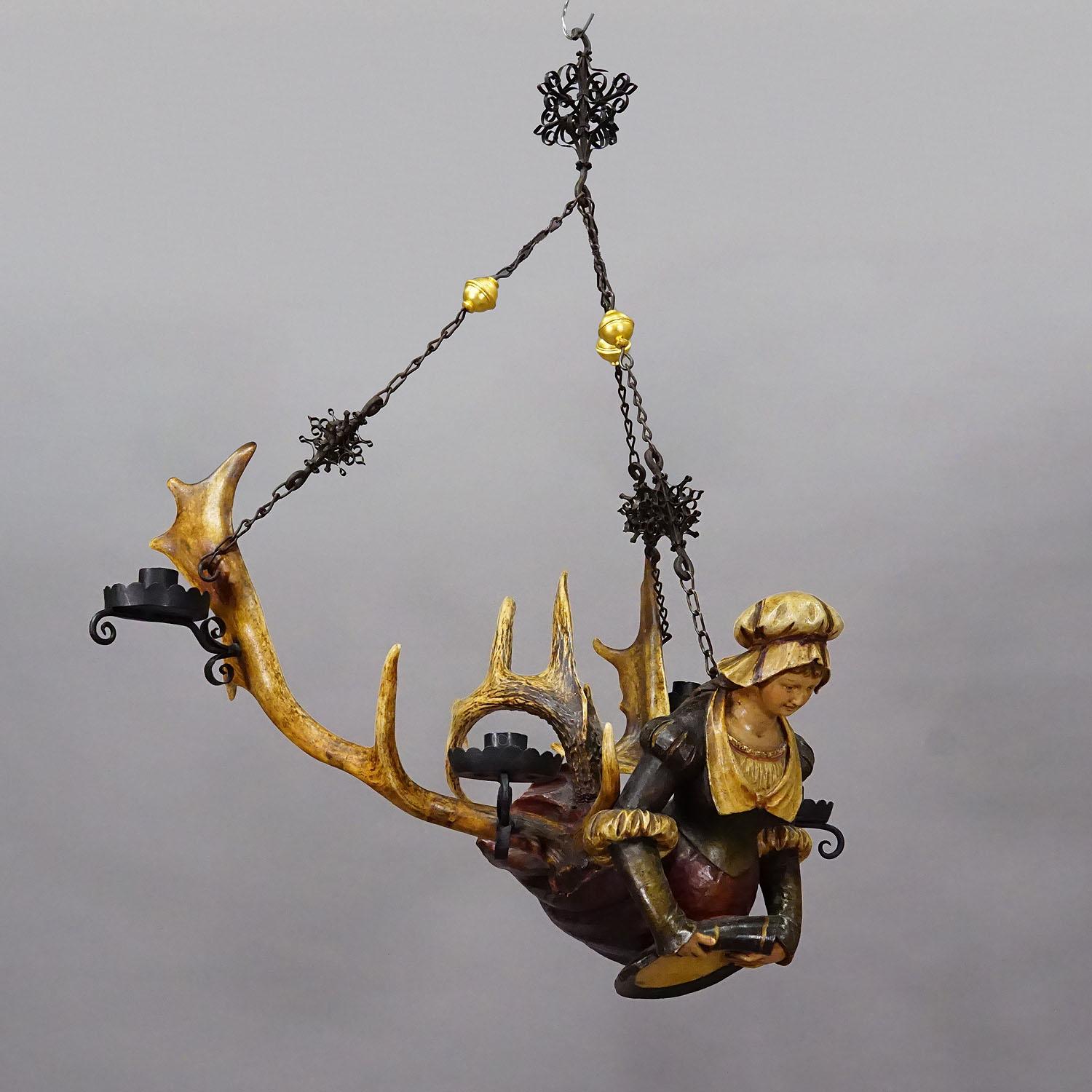 Antique Lusterweibchen of a Medieval Noble Lady ca. 1880s

A great antique chandelier featuring a medieval noble lady holding a blazon. The sculpture is made of handcarved and painted wood and mounted on a large pair of deer antlers. It comes with