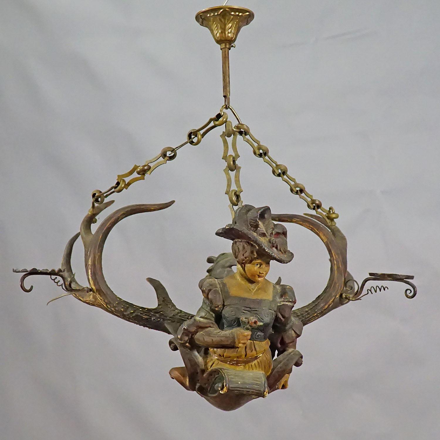 A rare antique lüsterweibchen chandelier with a plaster sculpture of a Victorian lady with original Virginia deer antlers and 2 iron spouts for candles. Executed circa 1900.

Measures: Length 16.54