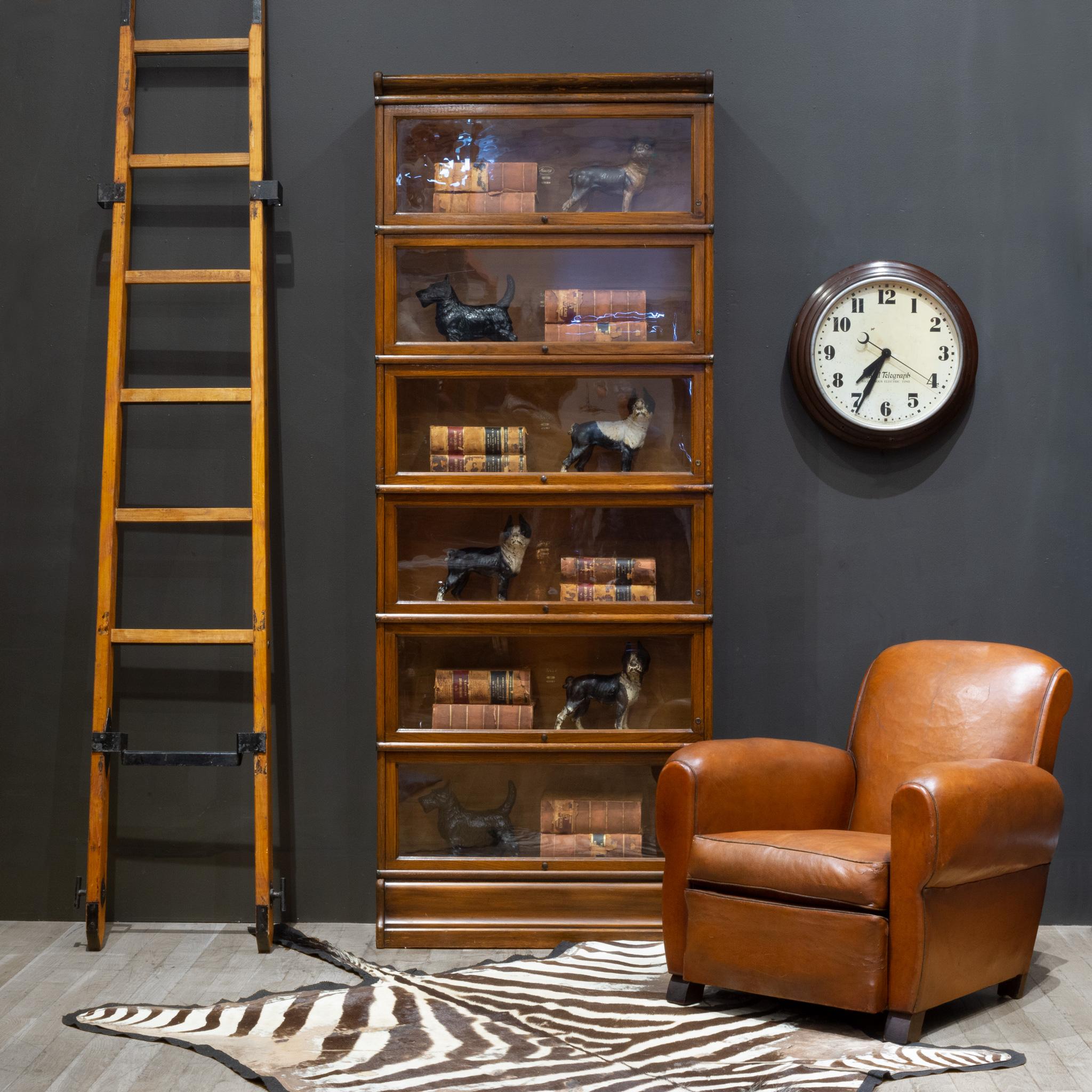 ABOUT

An antique Macey lawyer's or barrister's bookcase with patinated brass knobs, copper flashed bands on the sides and glass doors that open and slide in from the top. Quarter sawn dark Walnut finish with a Maple finish in the interior. Original