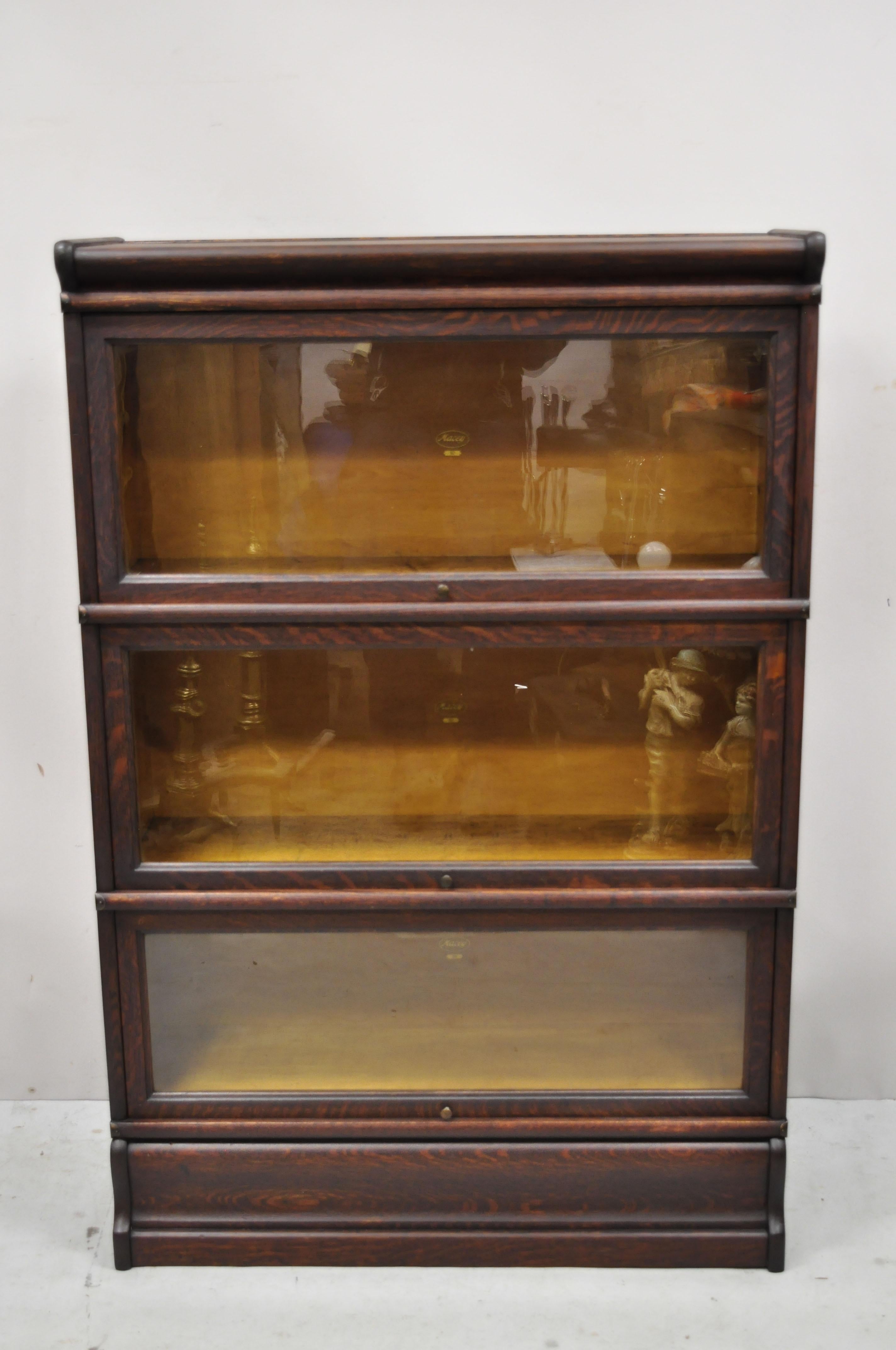 Antique Macey golden oak 3 section stacking barrister lawyers bookcase. Item features 3 oak sliding glass doors, 3 sections, beautiful wood grain, original label, quality American craftsmanship, great style and form. Circa Early 1900s. Measurements: