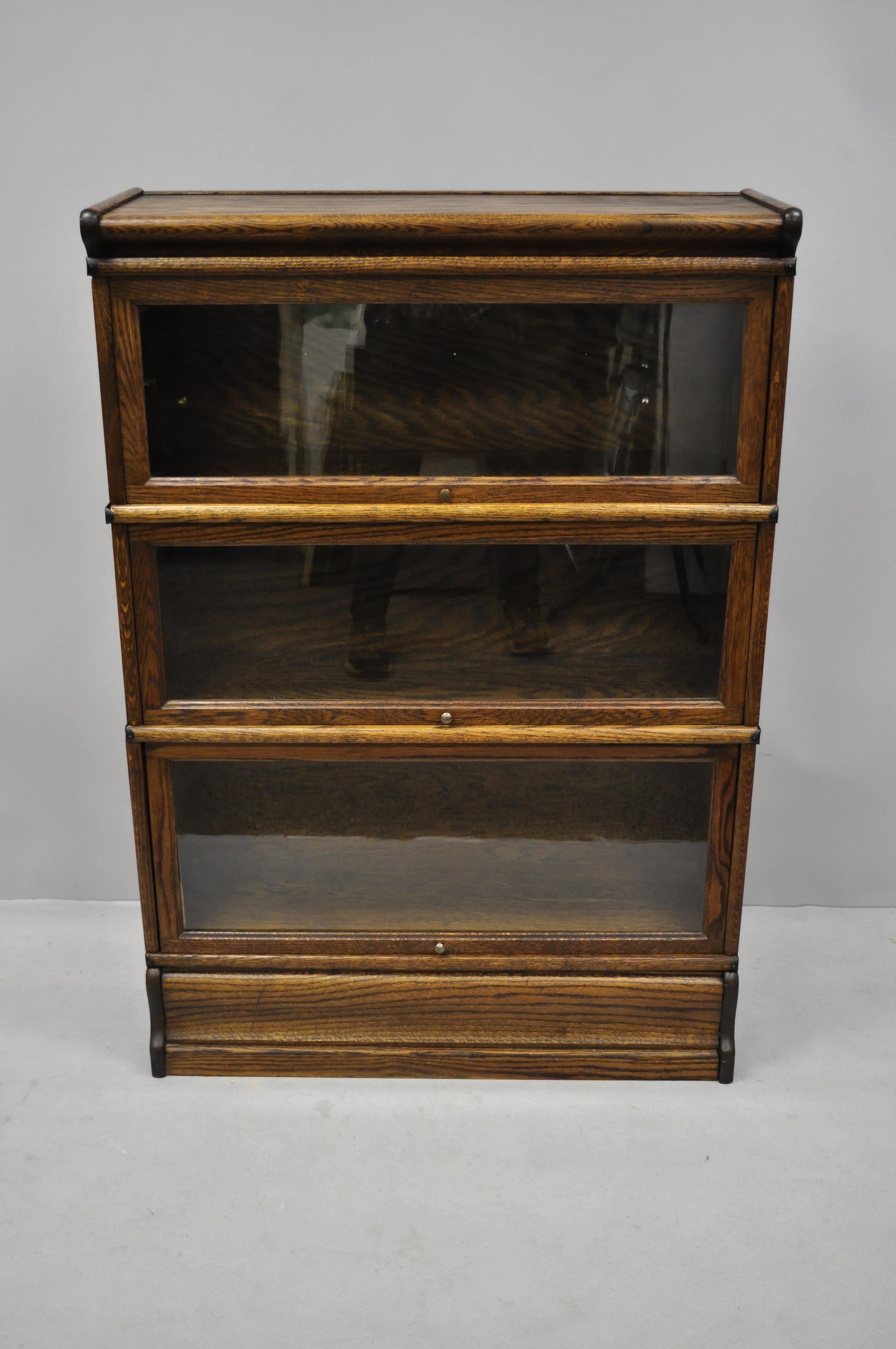 Antique Macey oak 3 section stacking lawyers Barrister bookcase. Item features 3 bookcase sections, glass doors, metal bands, beautiful wood grain, 5 part construction, circa early to mid-20th century. Measurements: 49