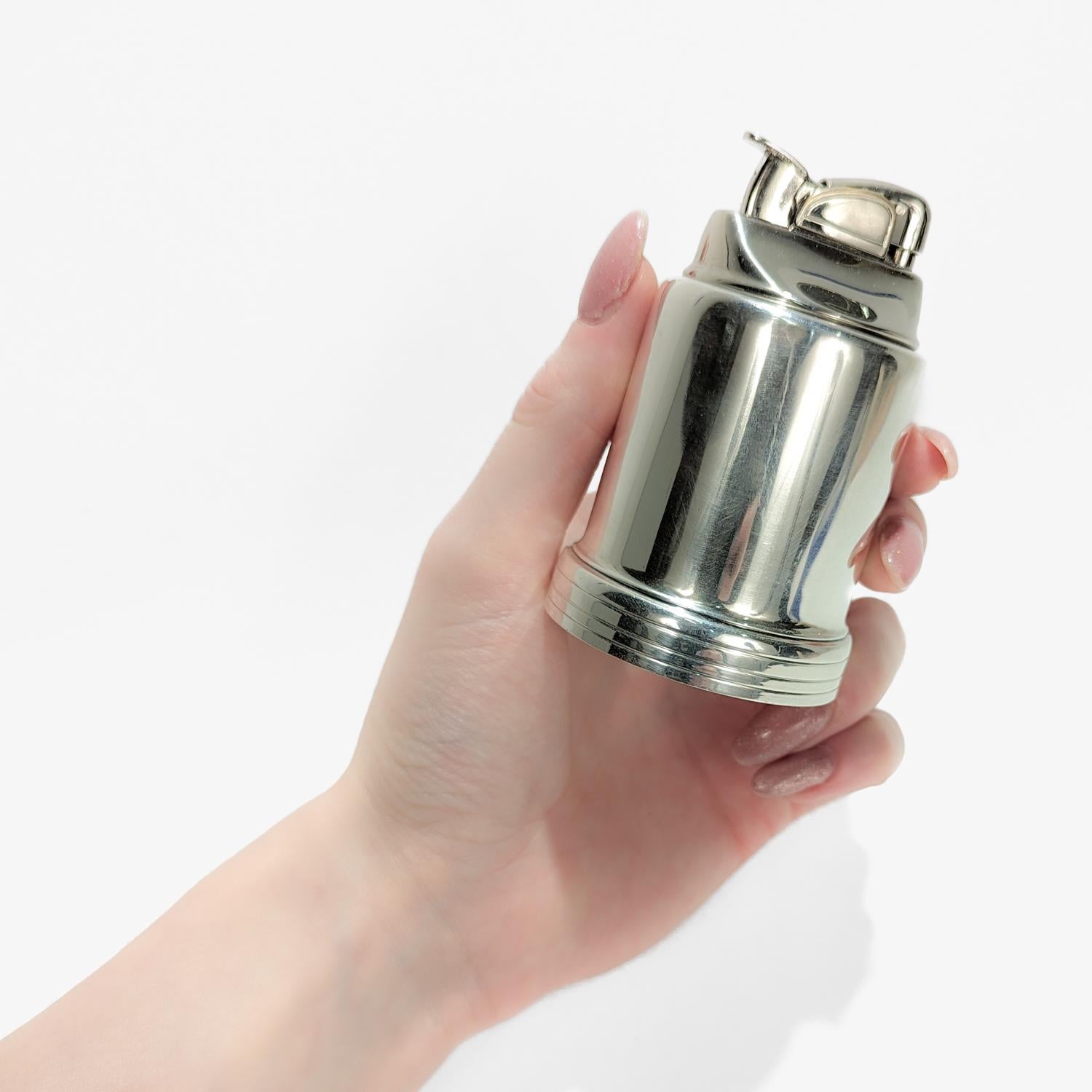 A fine Modernist table lighter.

By Tiffany & Co. 

In sterling silver. 

Marked to the base for Tiffany & Co. / Makers / Sterling / 23448 / T / 15. 

The lighter insert is removable. Marked to the base of the lighter insert with the Evans USA