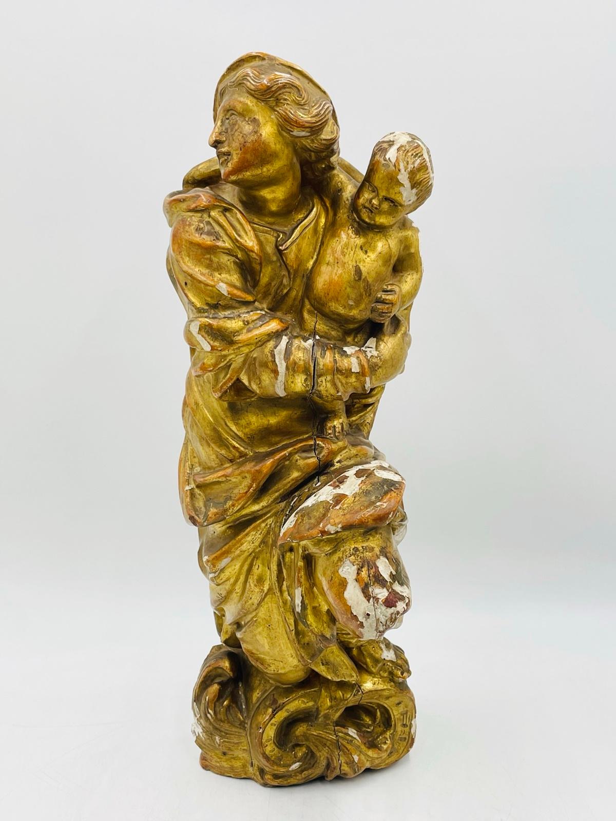 Introducing our exquisite Antique Madonna & Child Sculpture/Religious Icon, originating from 19th-century Italy. This captivating masterpiece showcases a stunning portrayal of a woman gracefully cradling a baby, symbolizing the iconic Madonna and