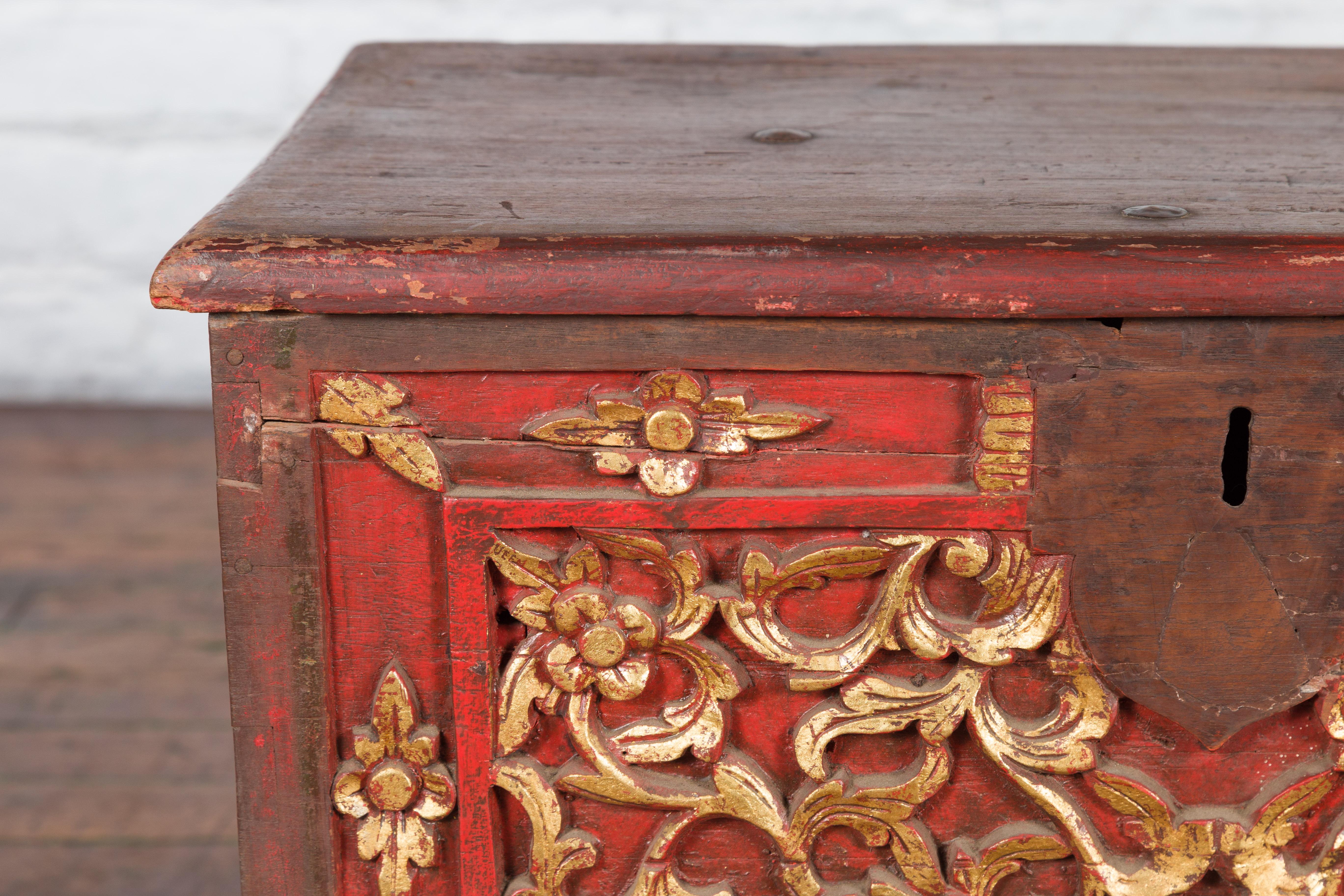 Indonesian Antique Madura Hand Carved Wooden Treasure Chest with Red and Gold Décor For Sale