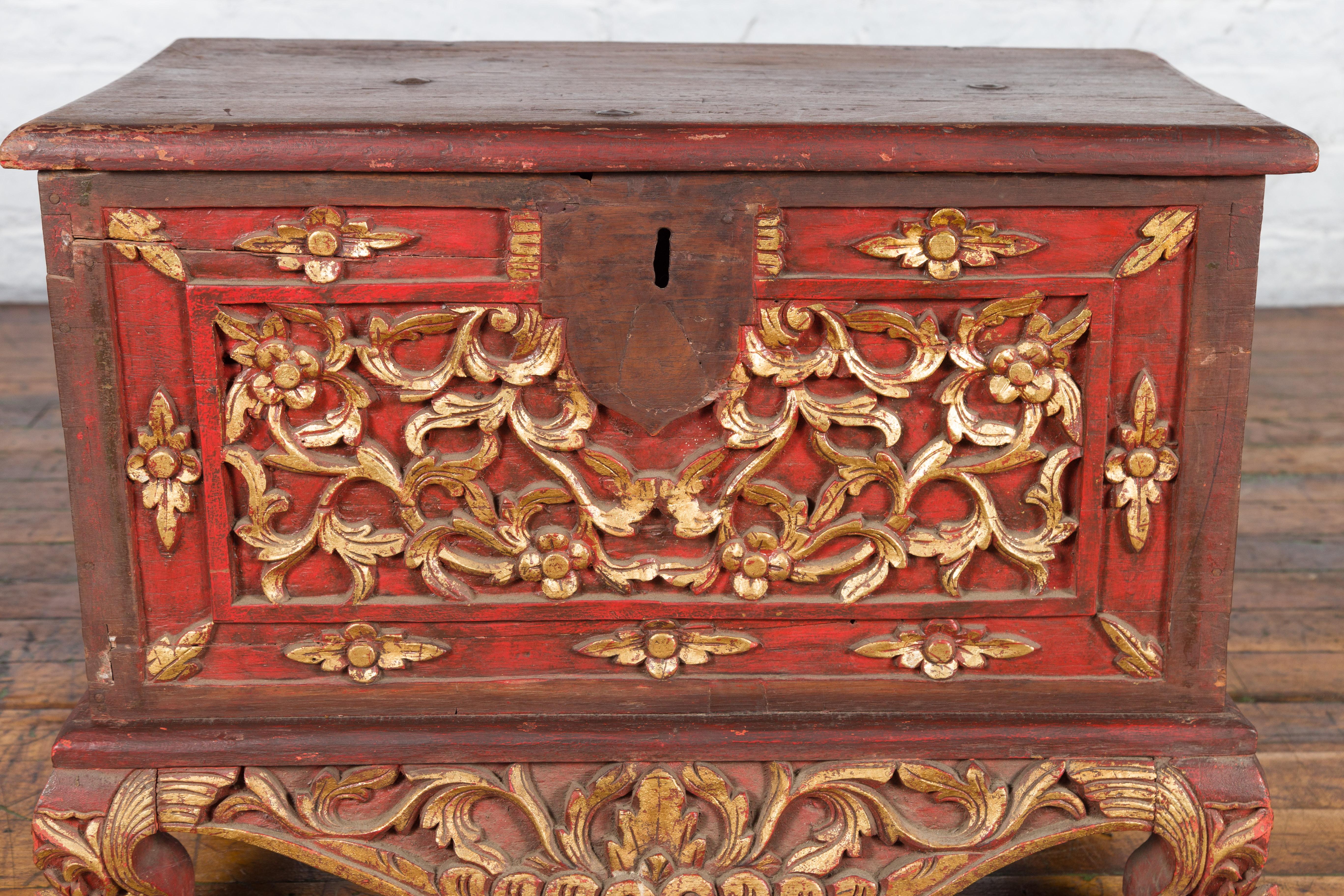 20th Century Antique Madura Hand Carved Wooden Treasure Chest with Red and Gold Décor For Sale