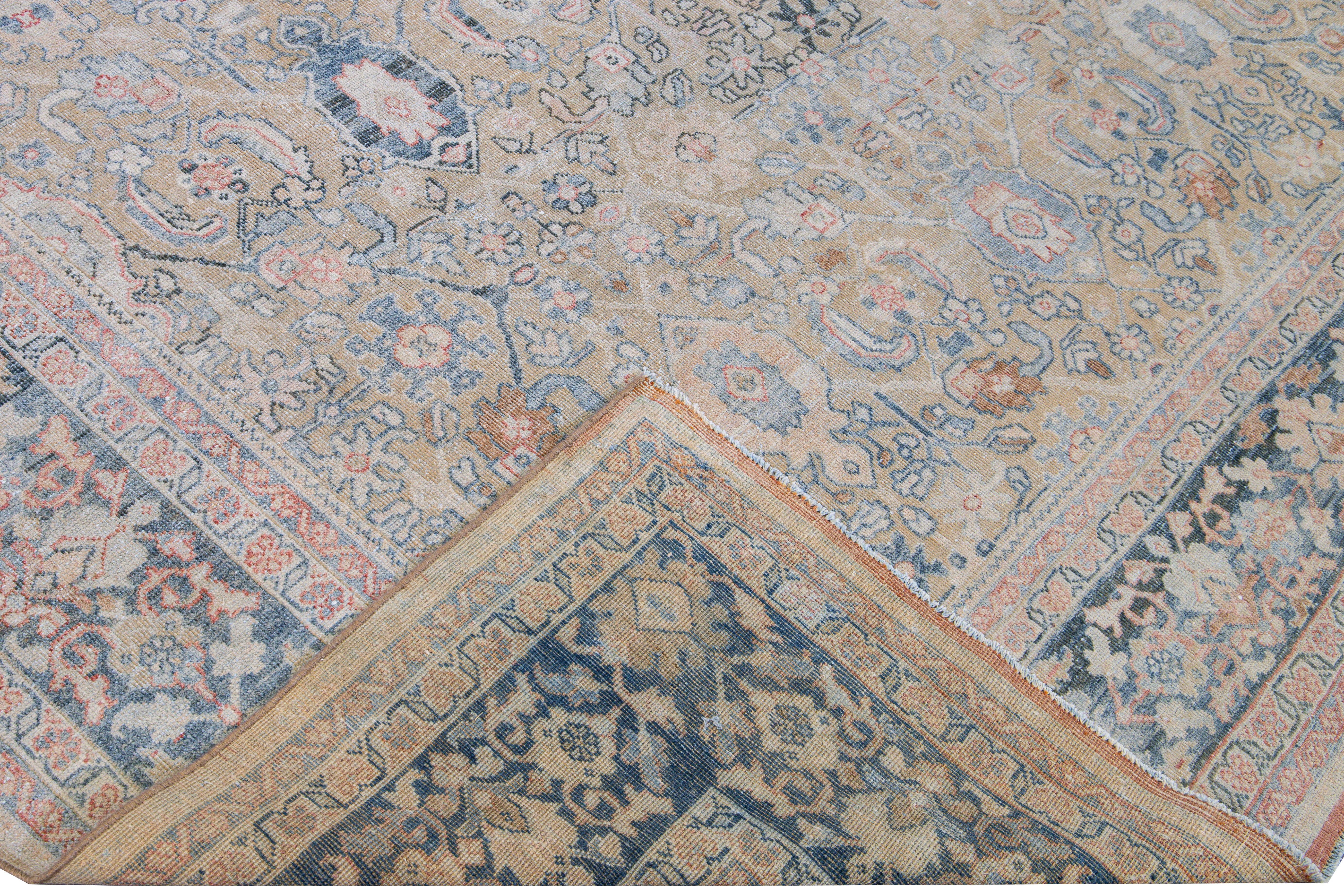 Beautiful hand-knotted antique Mahal wool rug with the beige field. This Persian rug has a blue frame and pink accents featuring a traditional floral pattern design. 

This rug measures 9'1