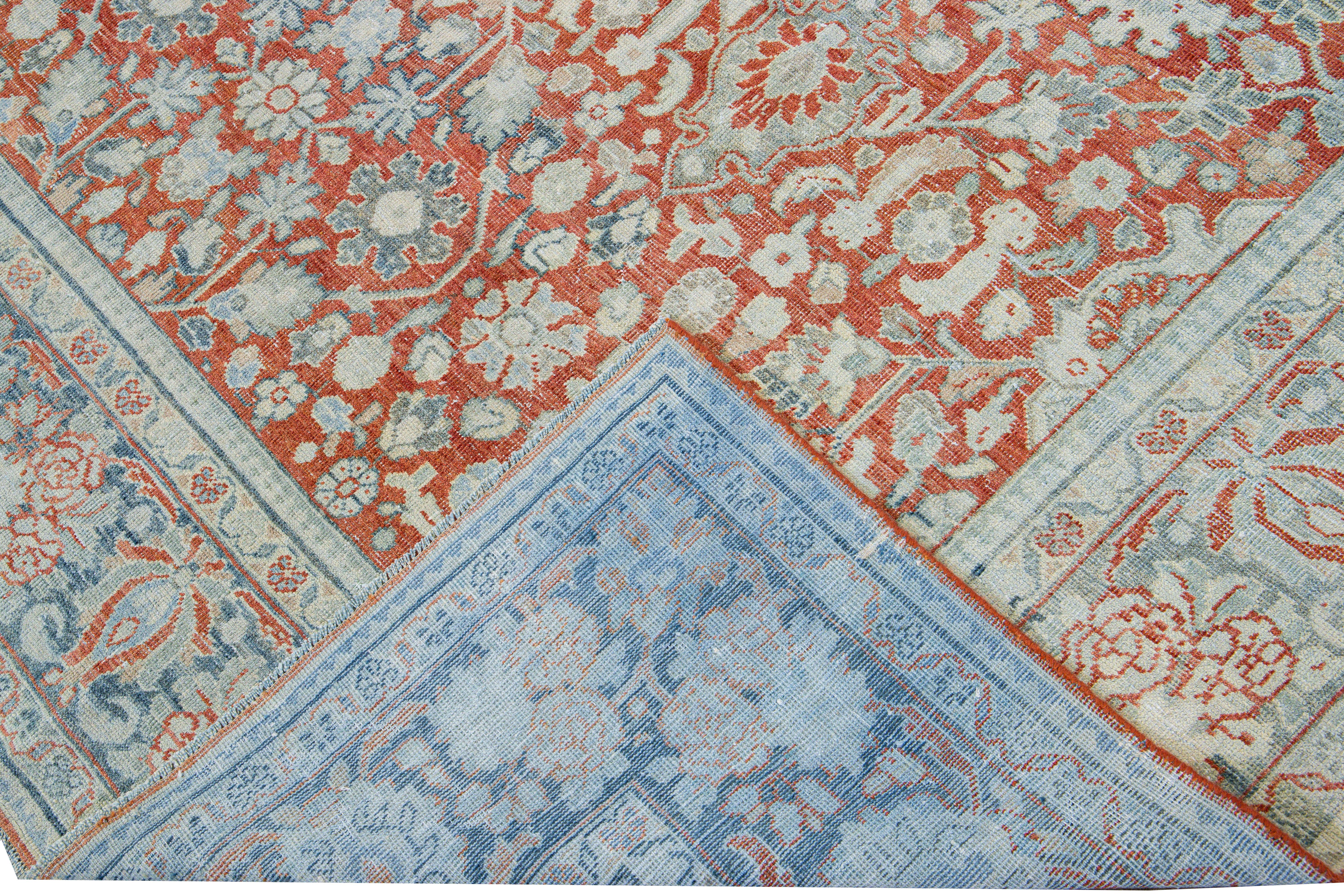 Beautiful hand-knotted antique Mahal wool rug with the red field. This Persian rug has a blue frame and ivory accents featuring a traditional floral pattern design. 

This rug measures 8'6